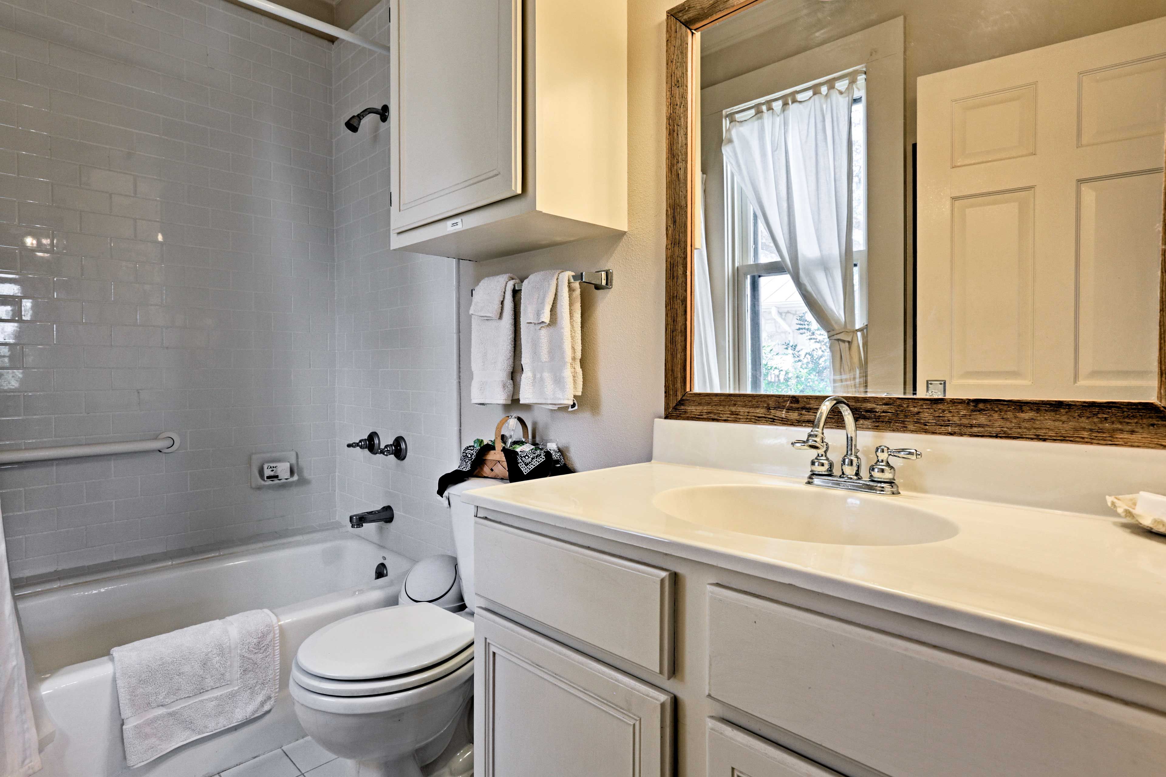 Wash up in the first bathroom, equipped with a single vanity & shower/tub combo.