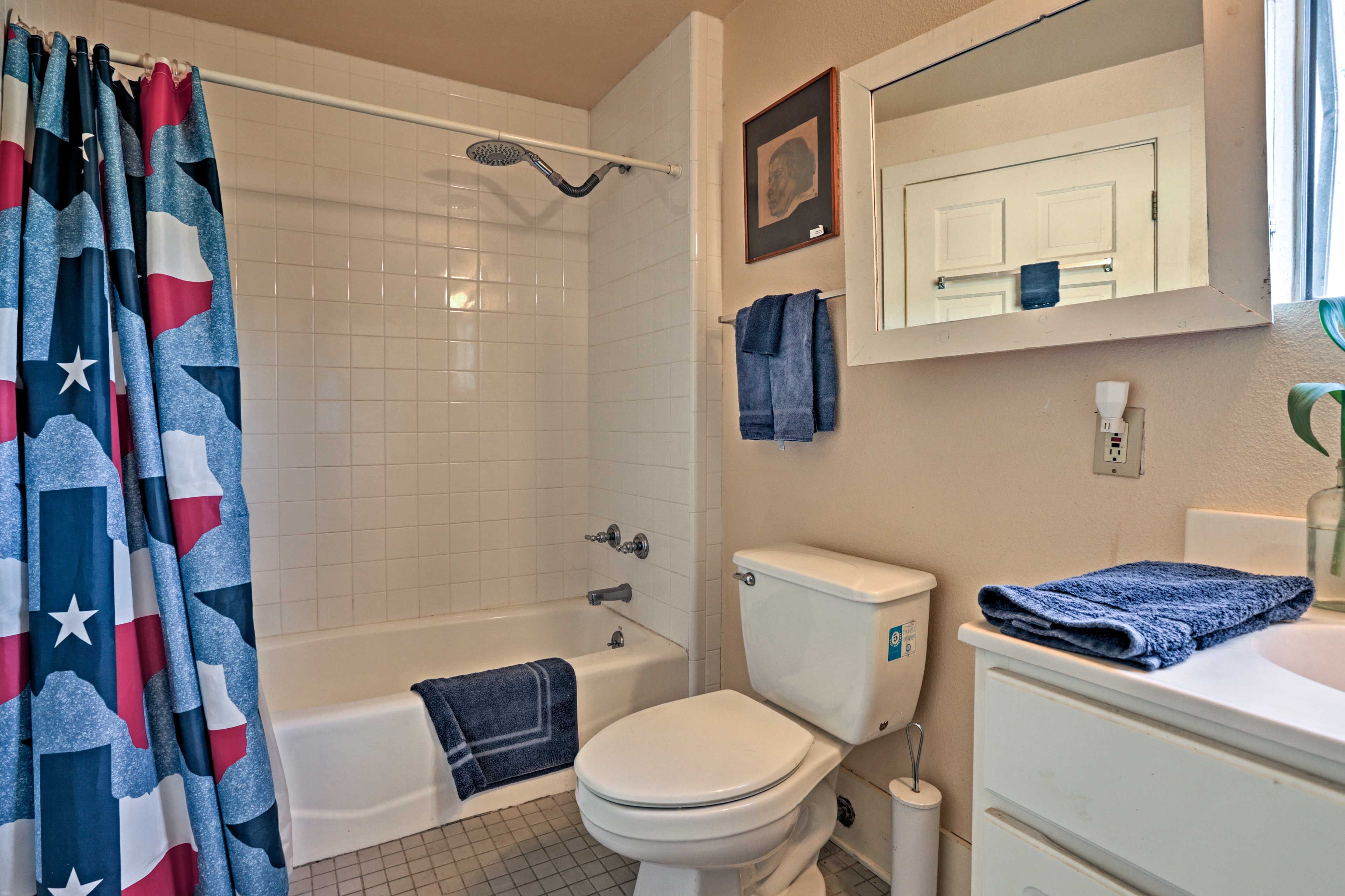 Wash up in the bathroom equipped with a single vanity and shower/tub combo.