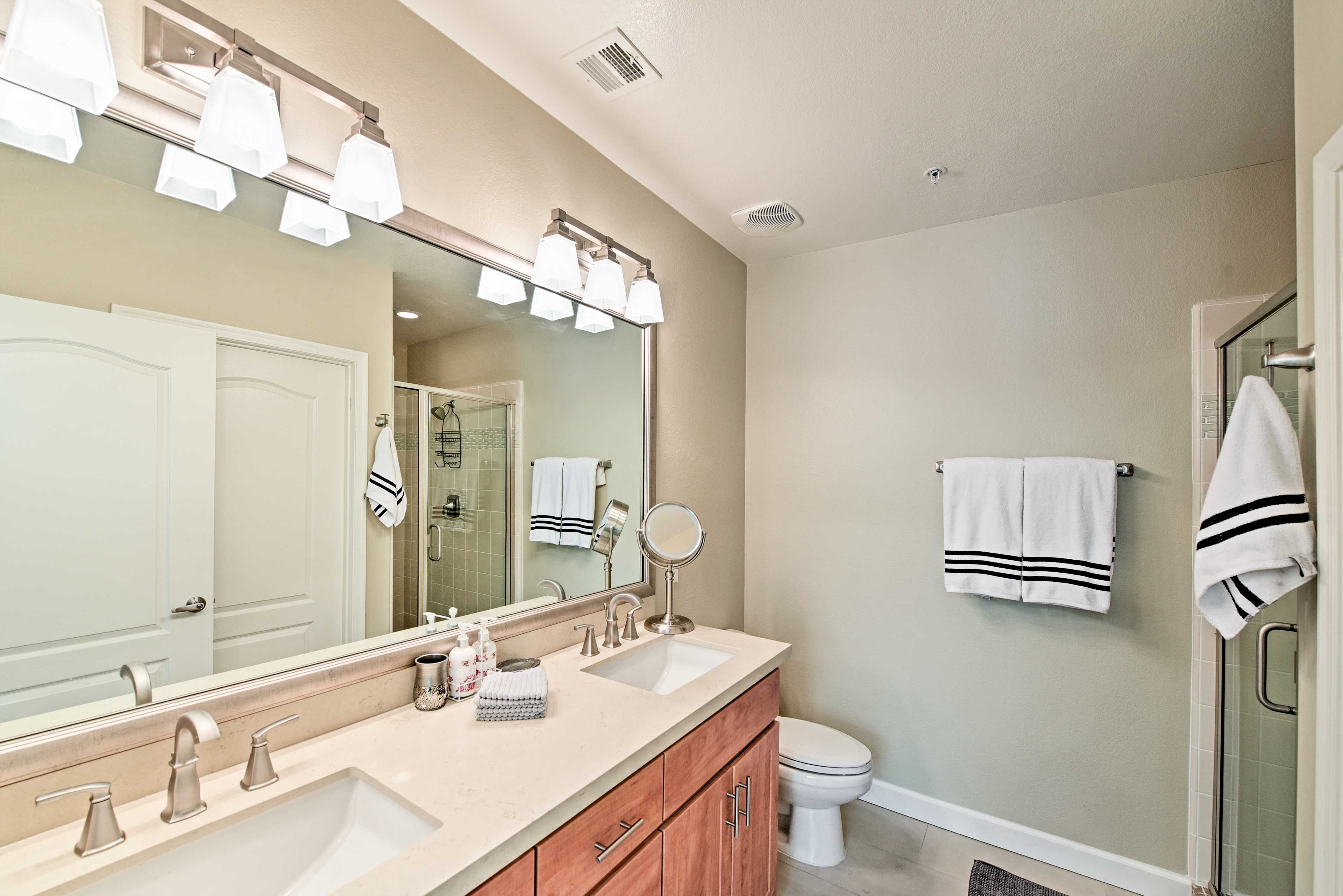 The en-suite bathroom is highlighted by a dual-sink vanity.