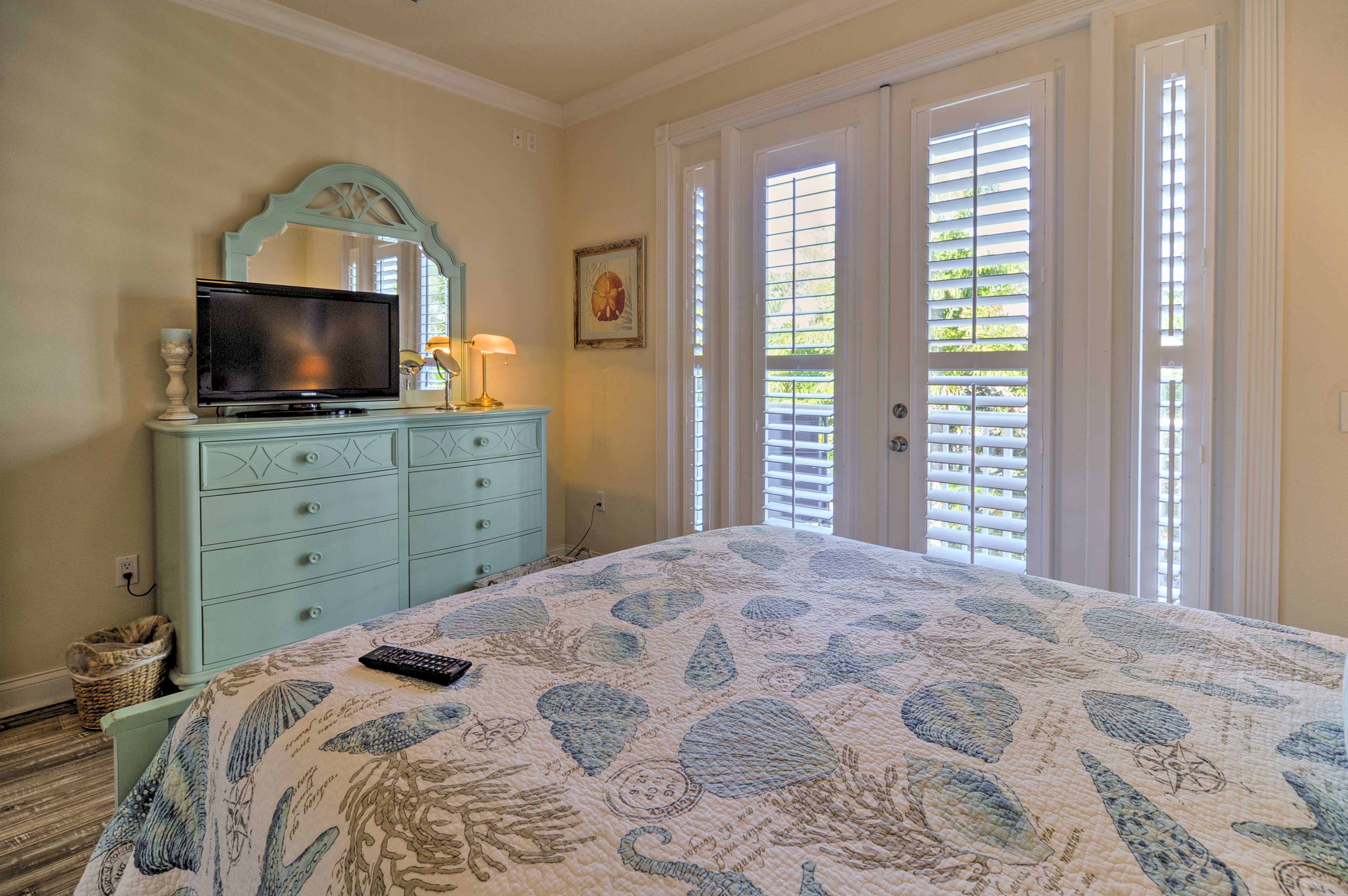 Curl up in this plush queen bed to watch a movie from under the covers.