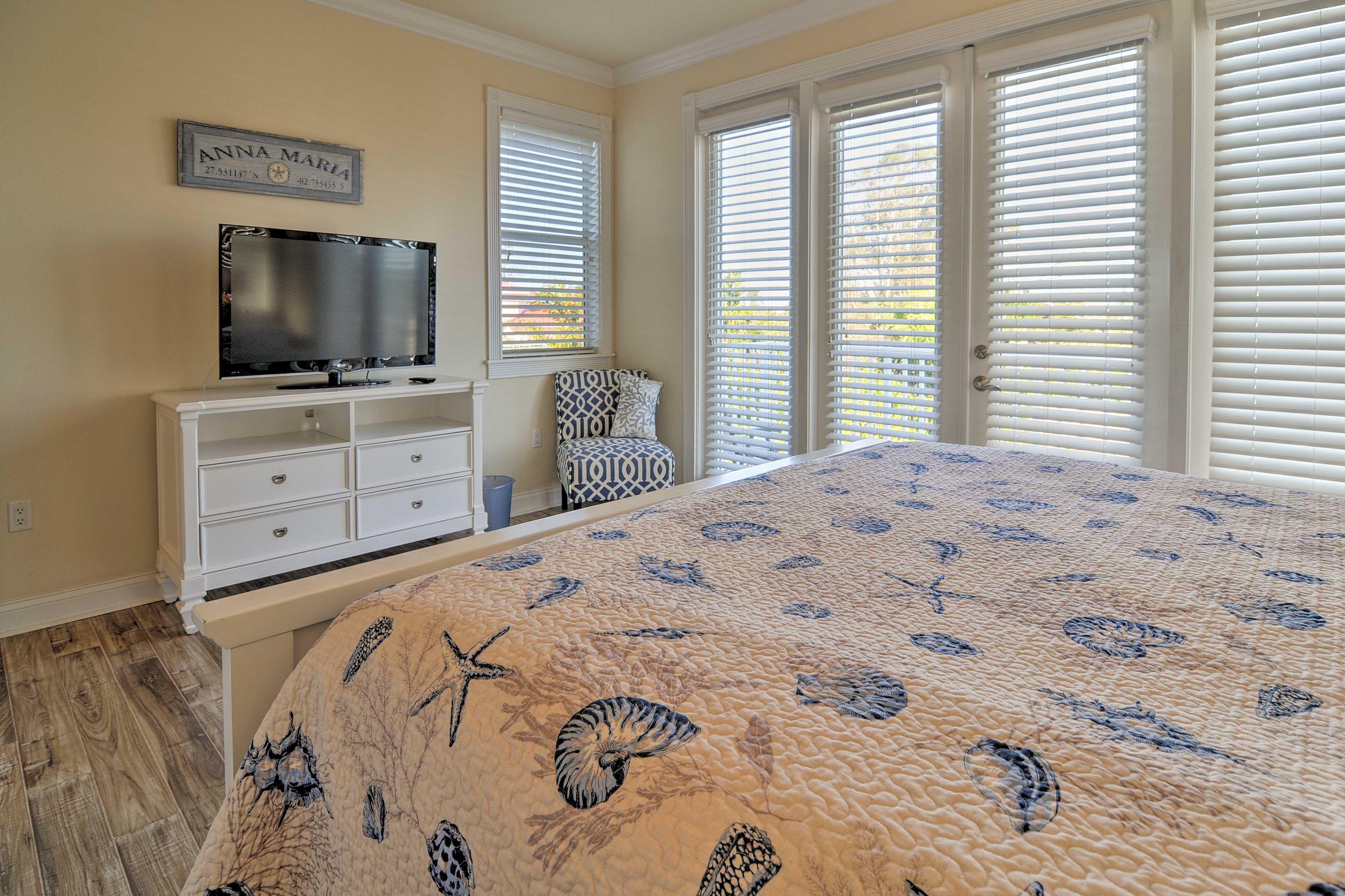 This bedroom features a king-sized bed, flat-screen cable TV and private deck.