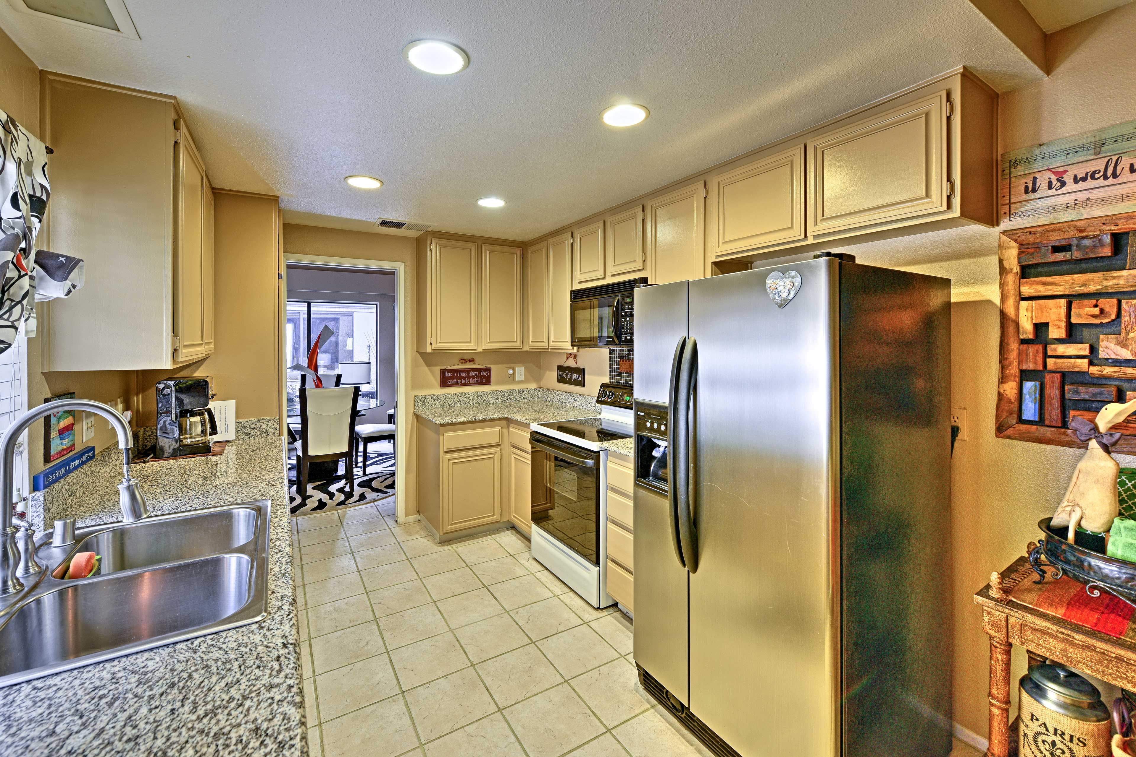 The kitchen is filled with stainless steel appliances.