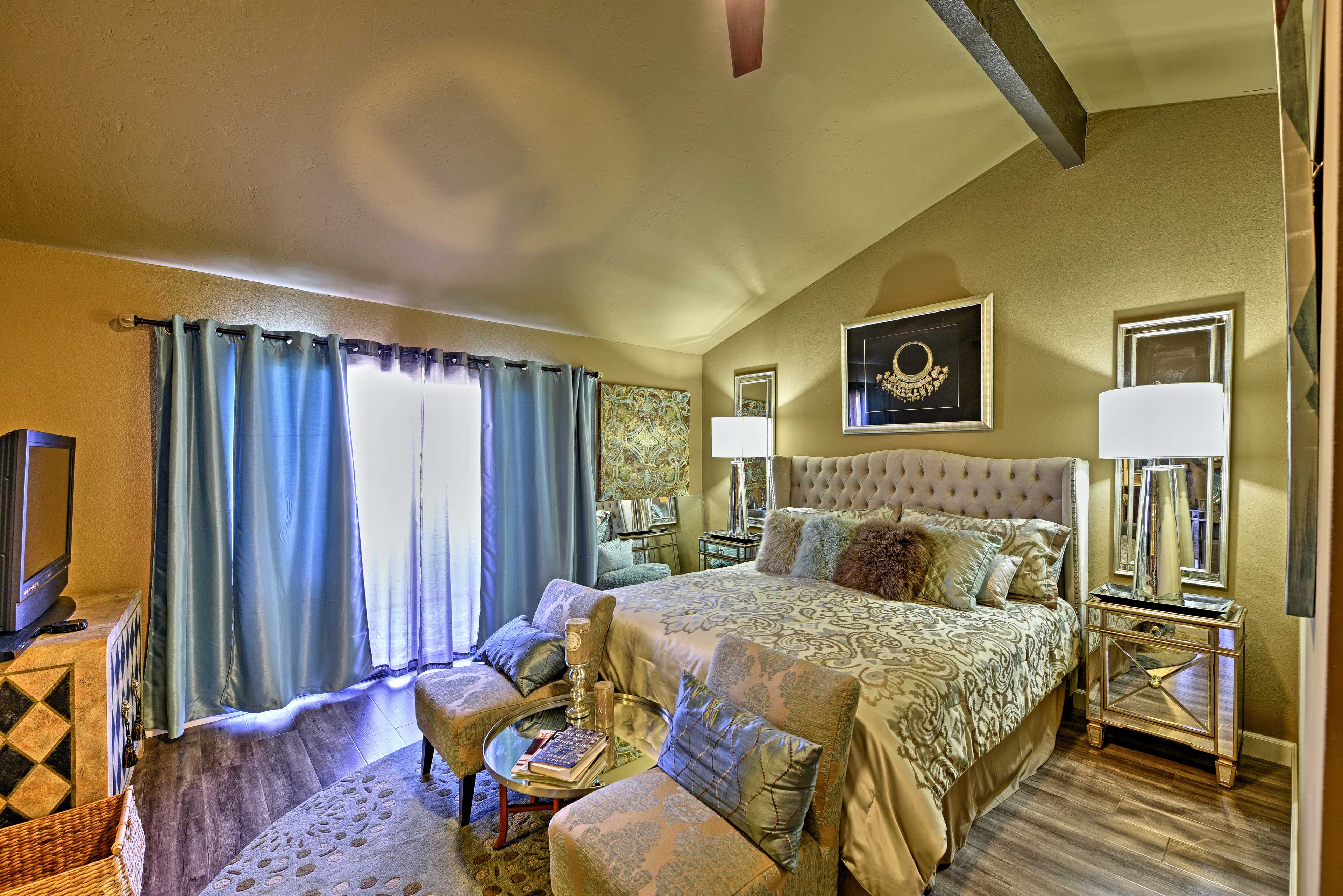 The first bedroom offers a king bed, access to a balcony, and gorgeous decor.