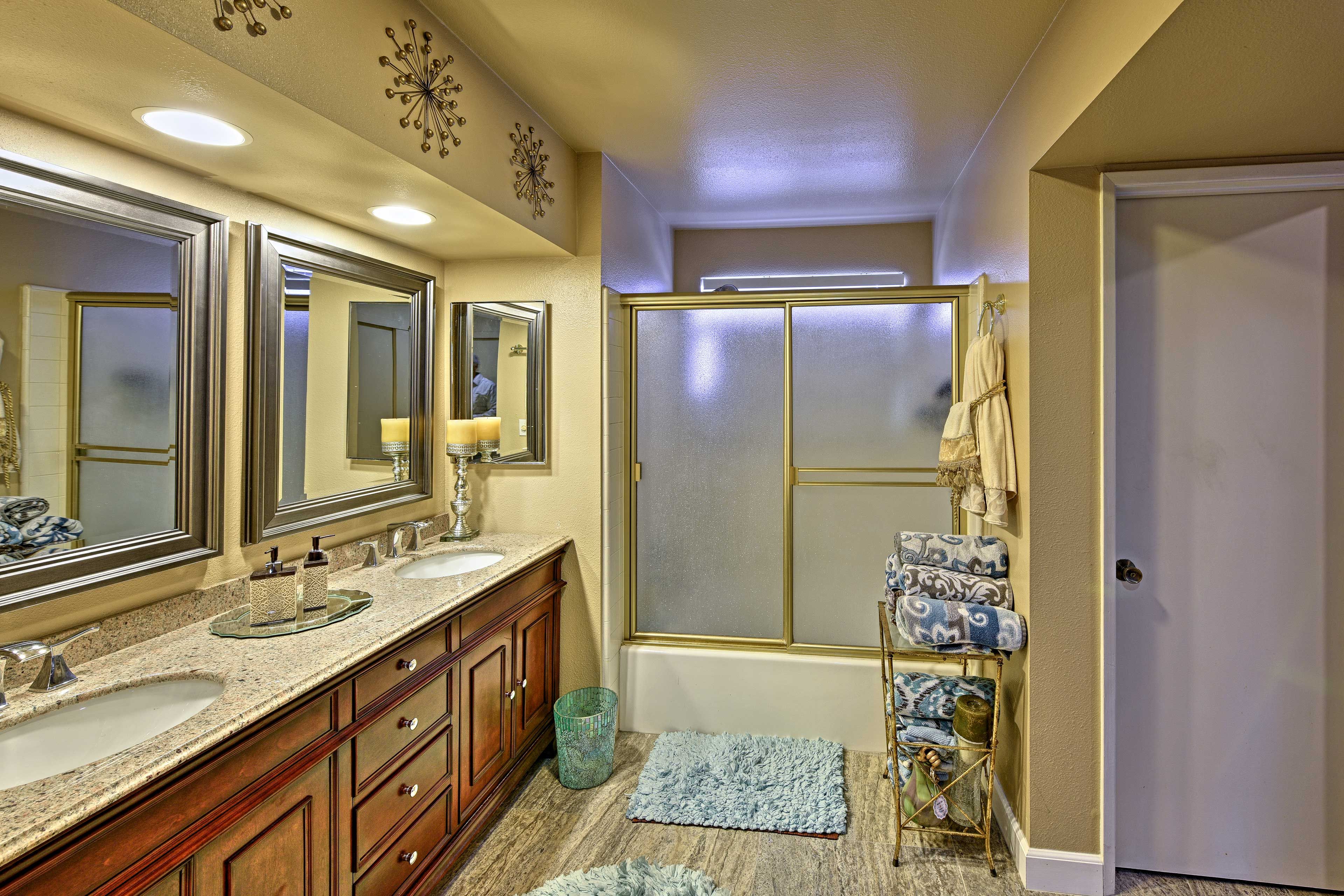 The en-suite bathroom offers dual sinks and a shower/tub combo.