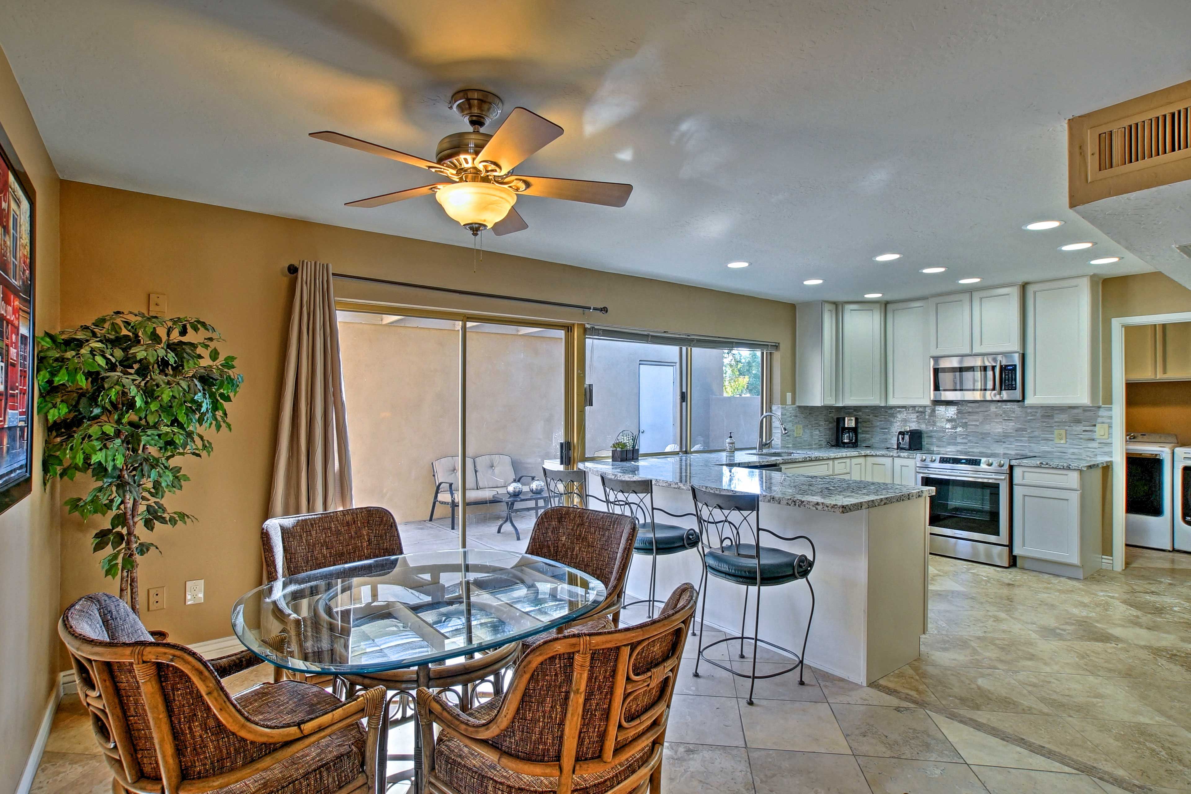 The kitchen has a 3-person breakfast bar and a 4-person table.