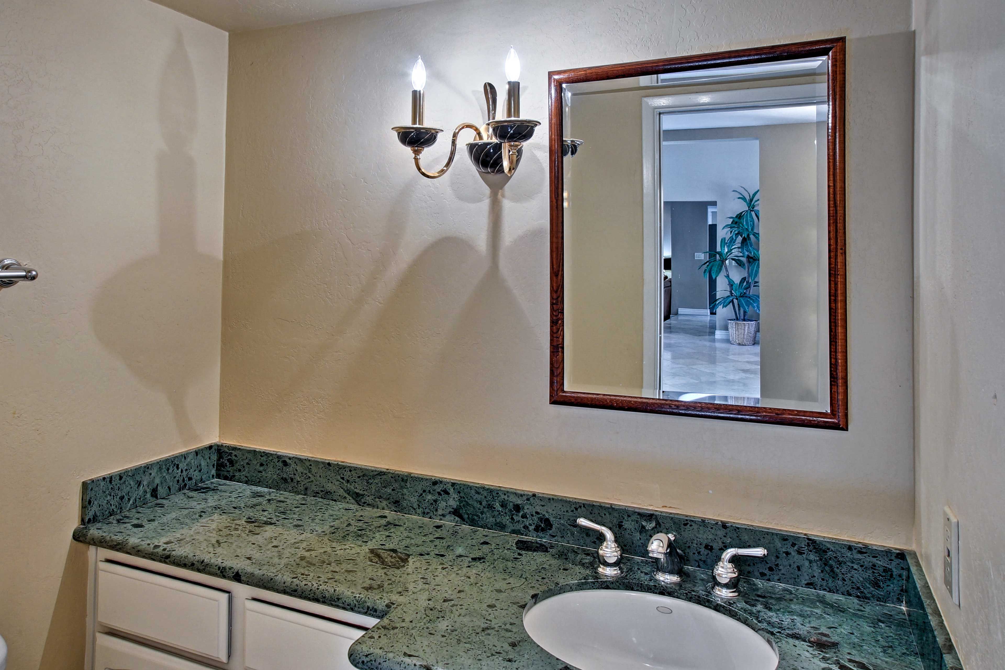 A half bathroom is located next to both living rooms.