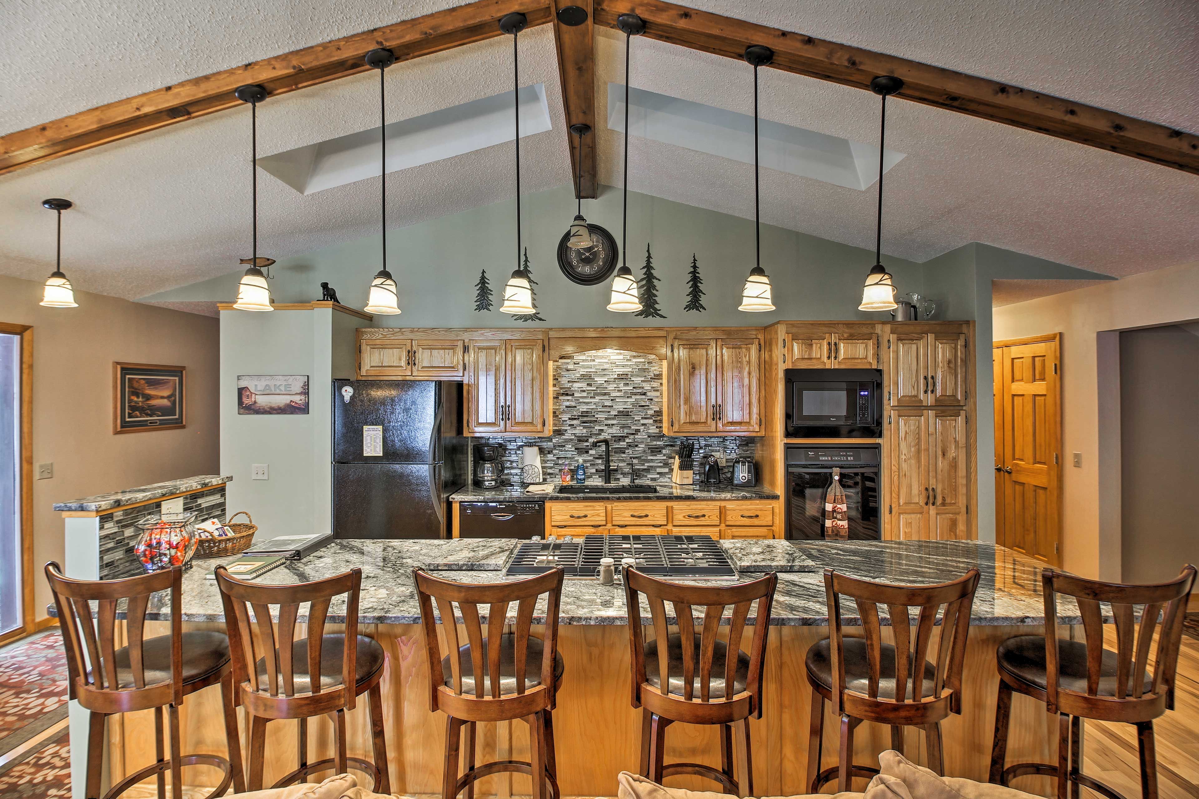 Head to the fully equipped kitchen with granite counters and a large island.