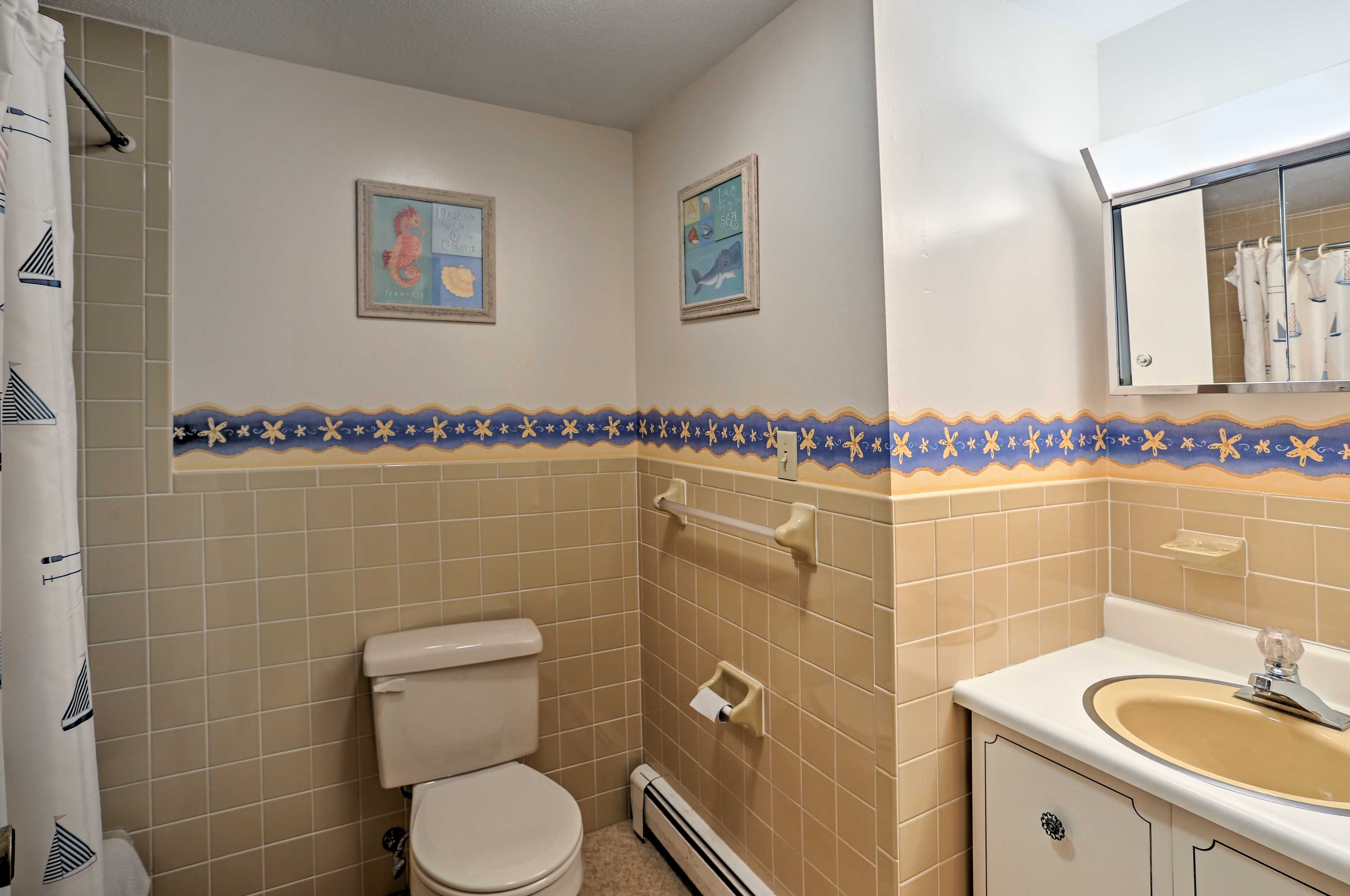This full bathroom has a shower/tub combo.