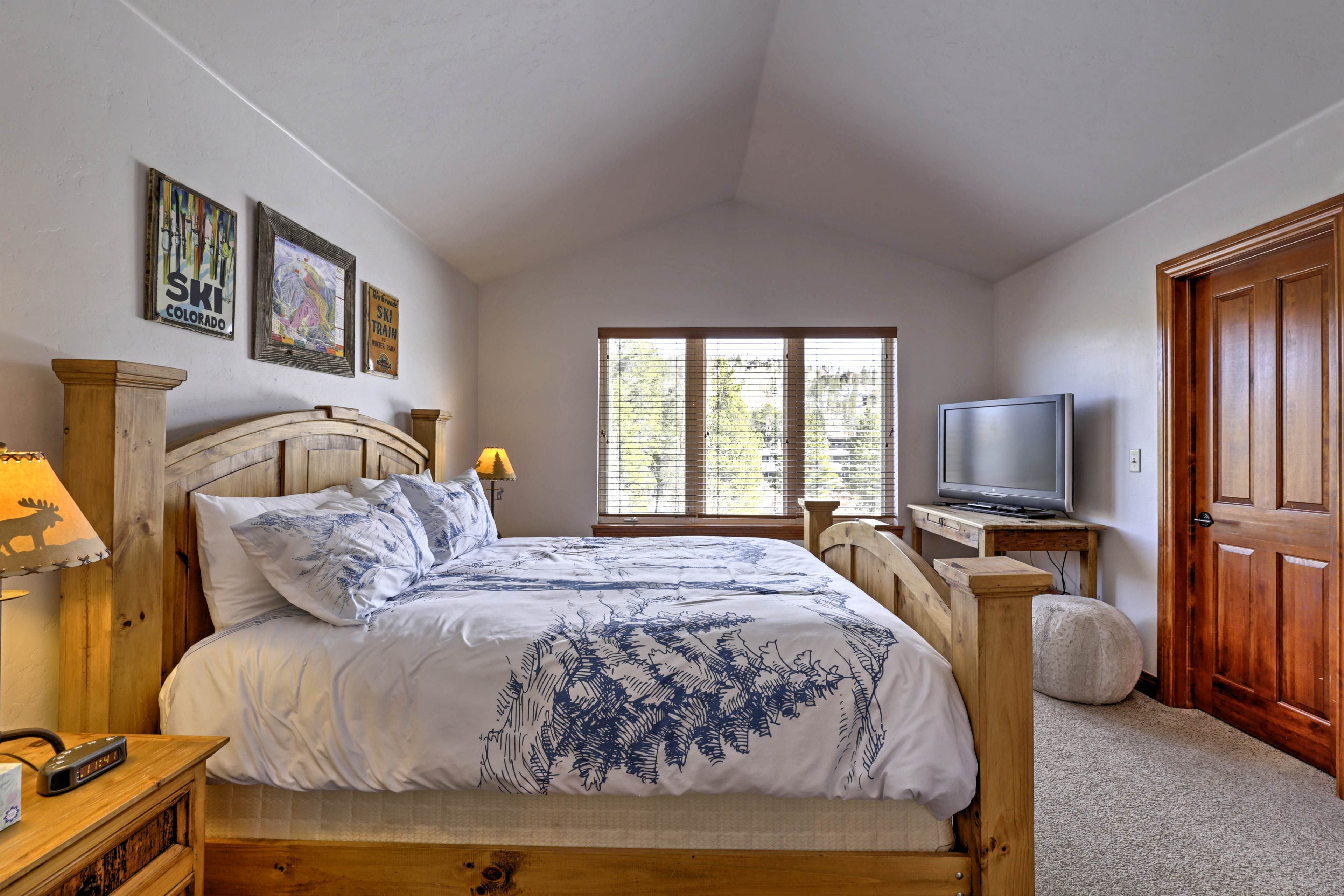 The master bedroom features a king bed, flat-screen TV and en-suite bathroom.