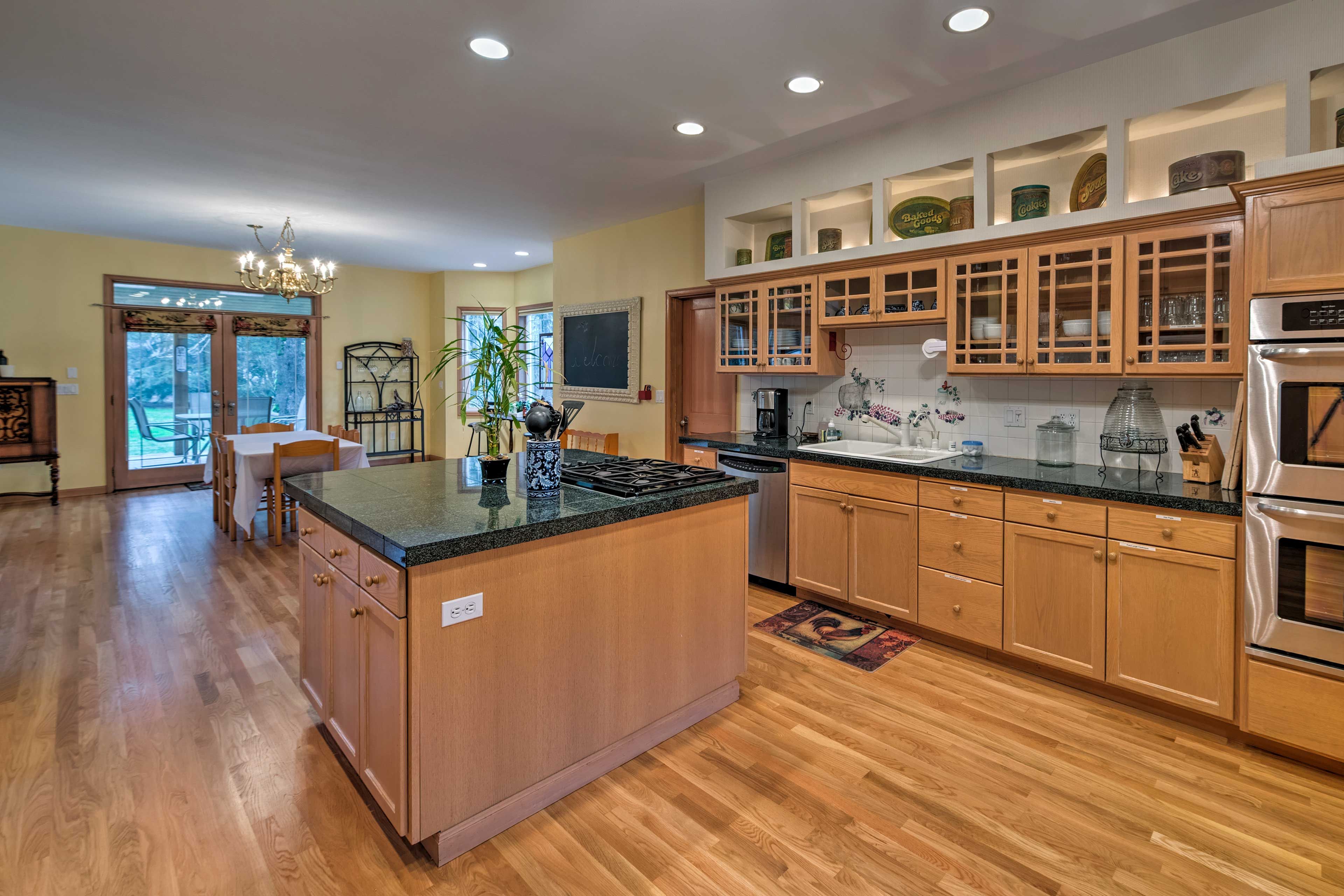 The kitchen has stainless steel appliances, granite counters, and an island.
