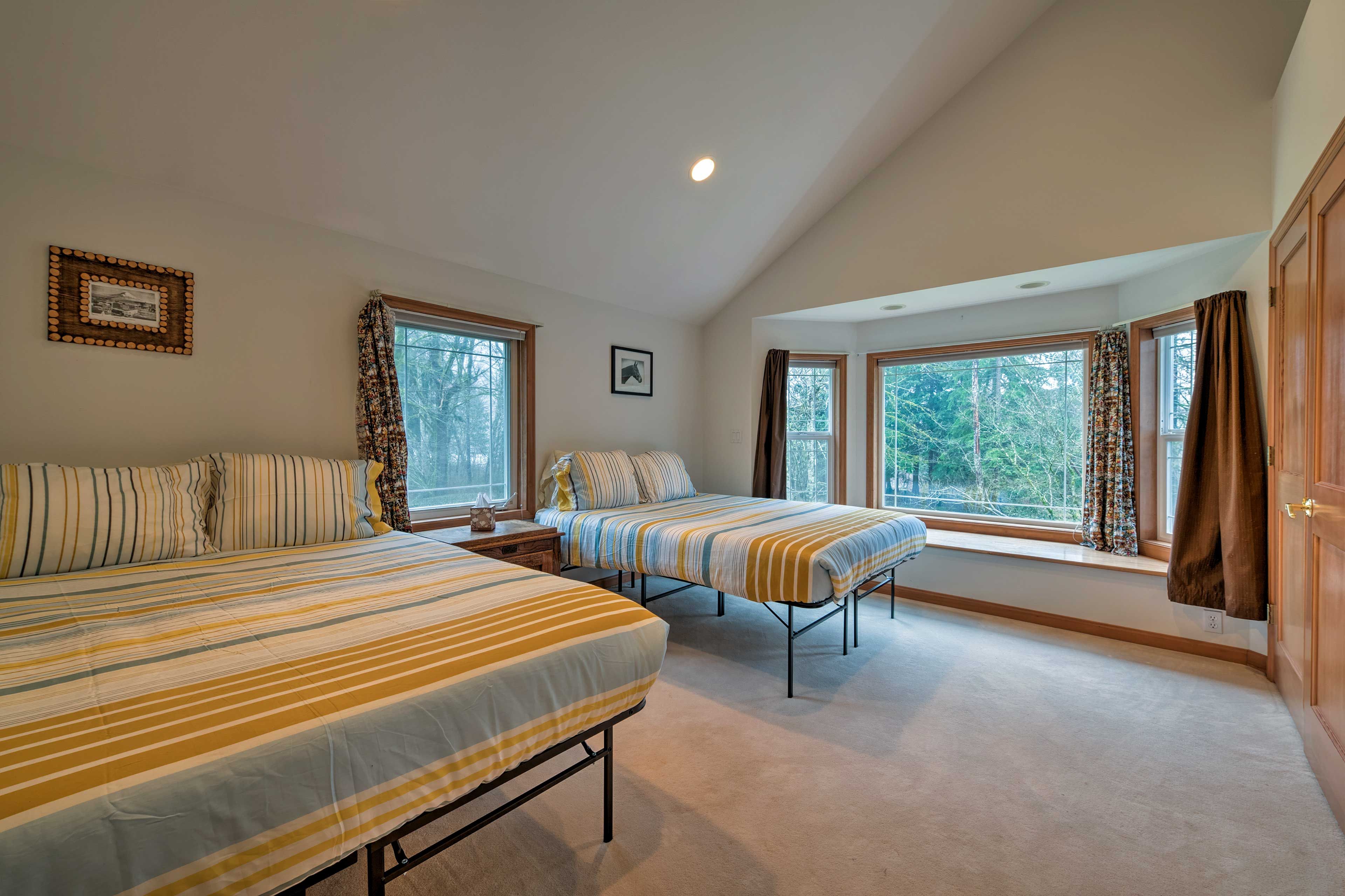 This second bedroom boasts 2 queen beds.