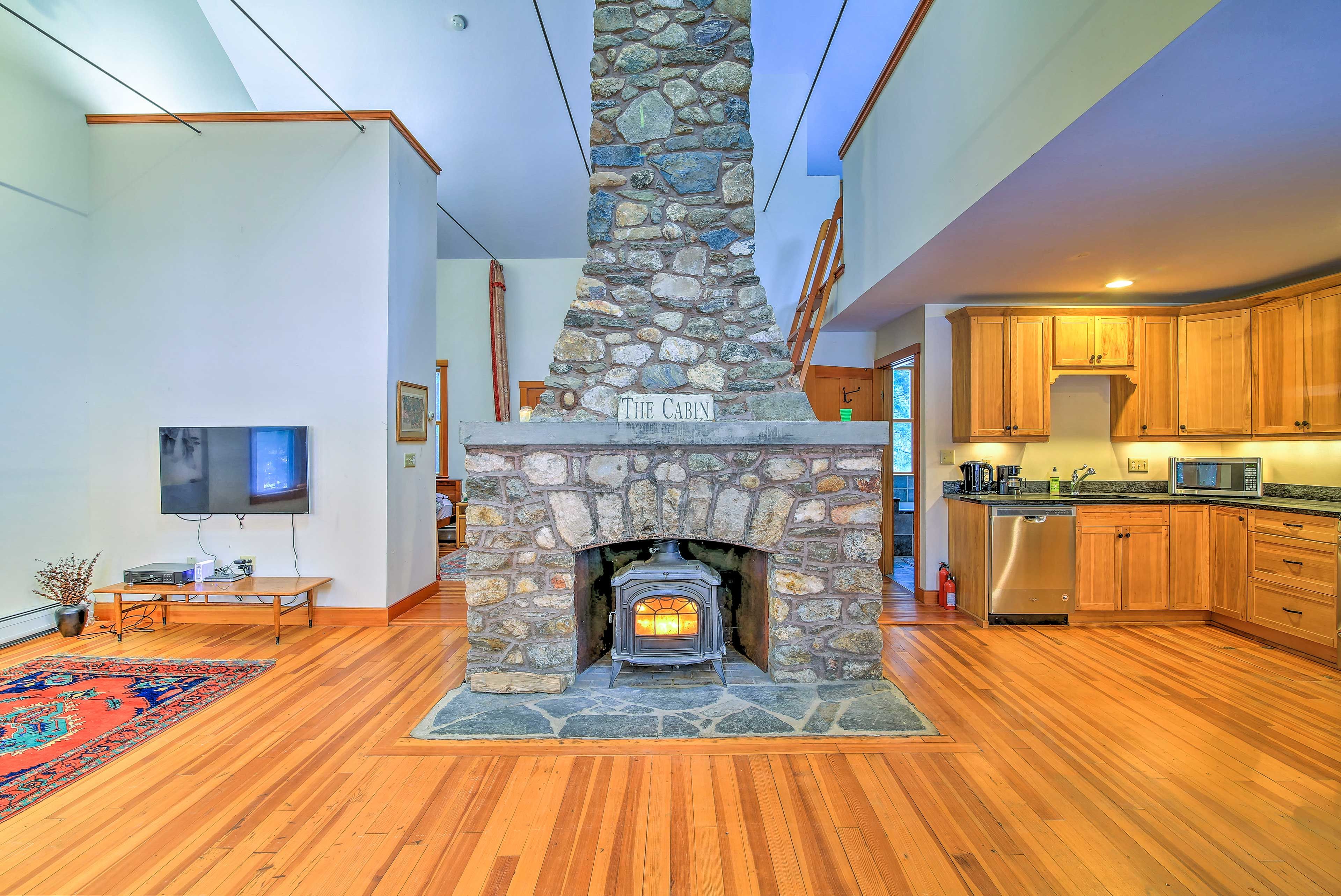 A floor-to-ceiling fieldstone fireplace highlights the living space.