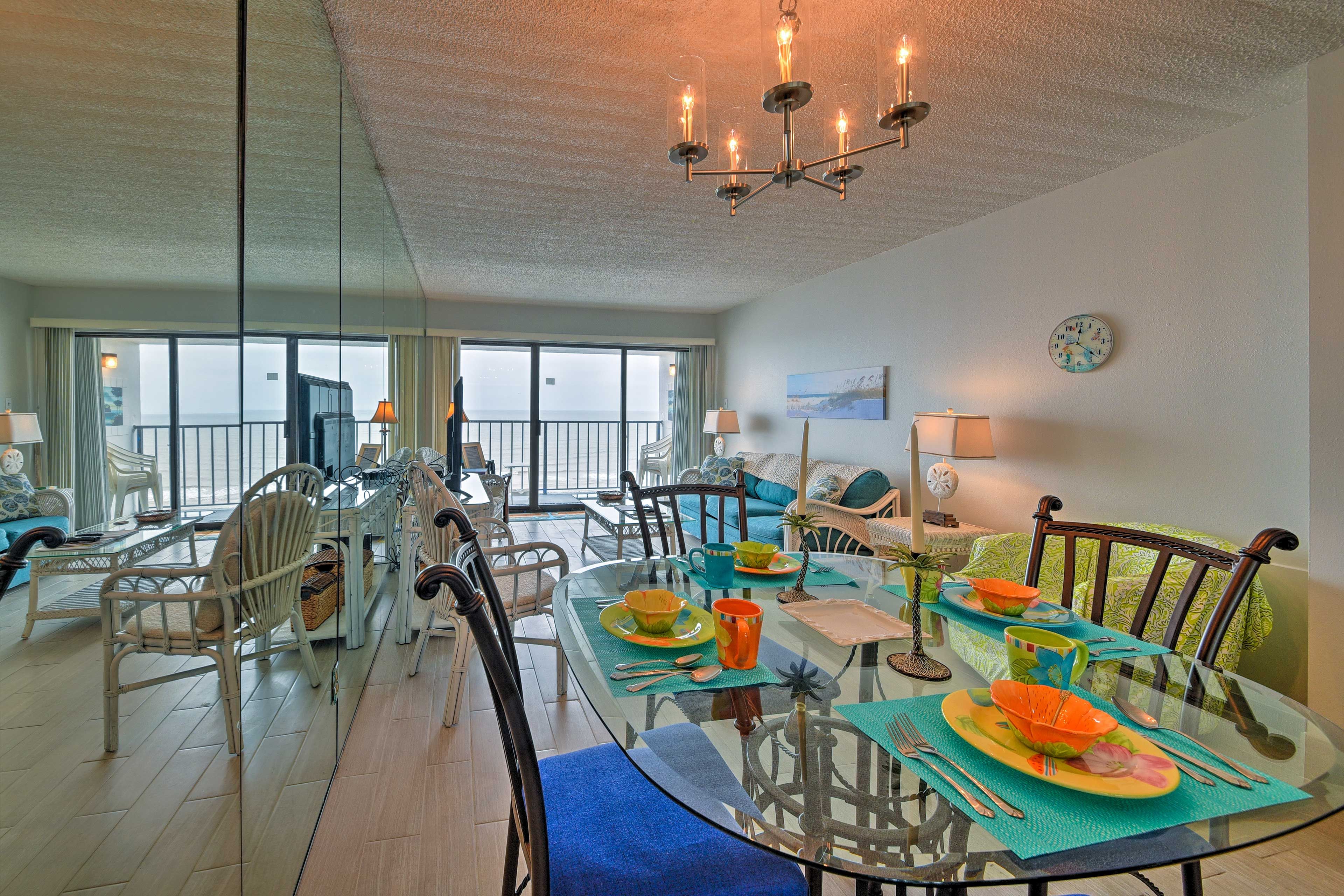 Share a meal with the whole group around the glass-topped table set for 4.