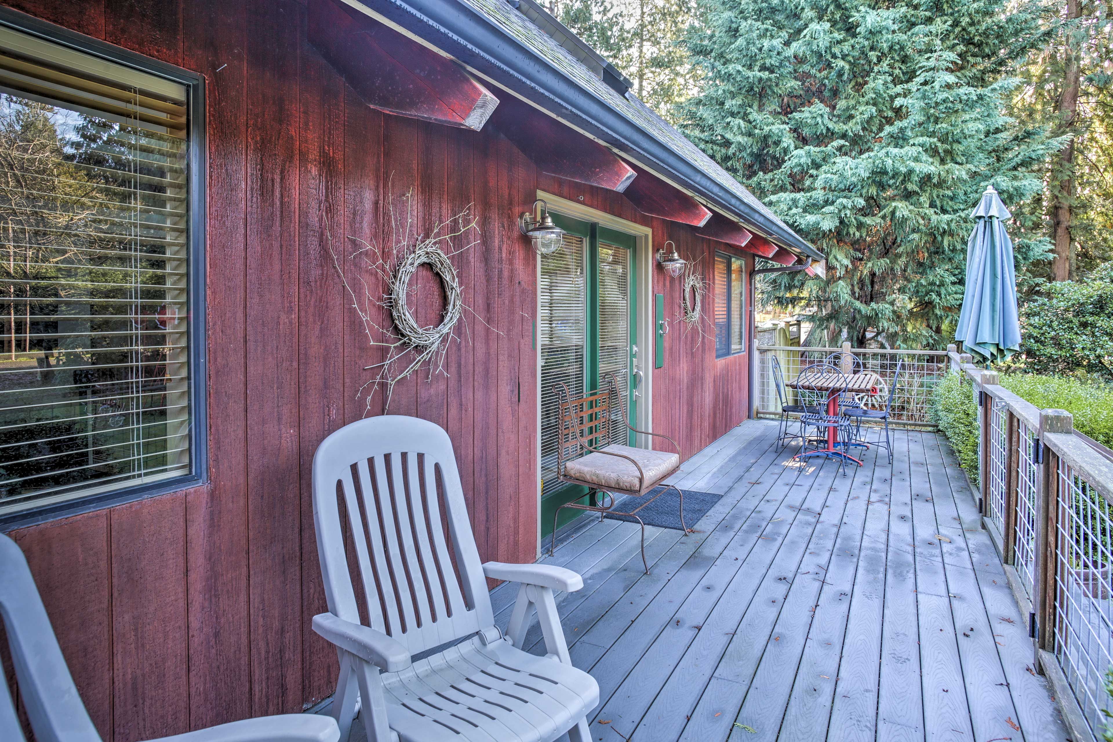 Dine al fresco on the porch featuring outdoor furniture.