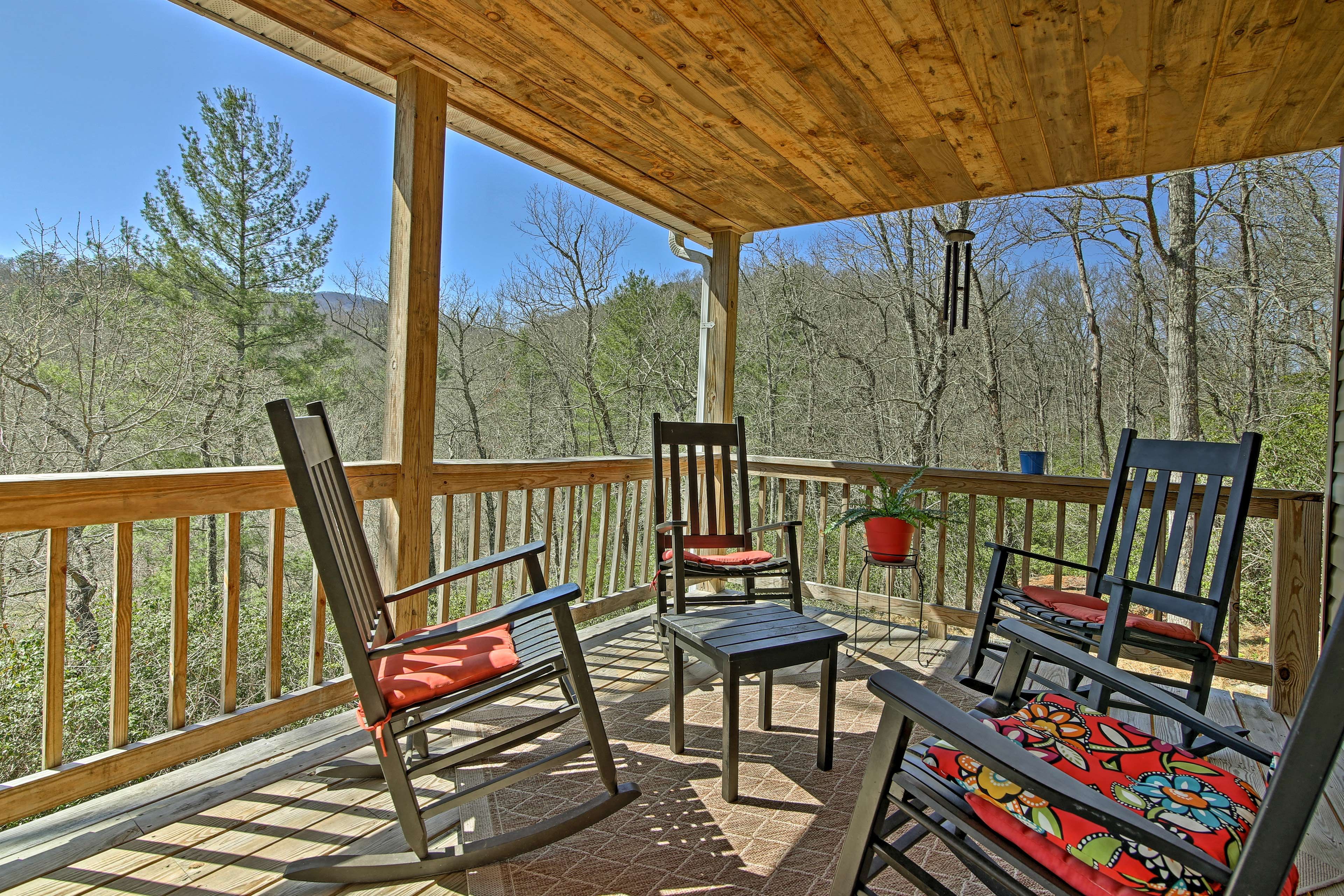 The covered deck includes comfortable rocking chairs.
