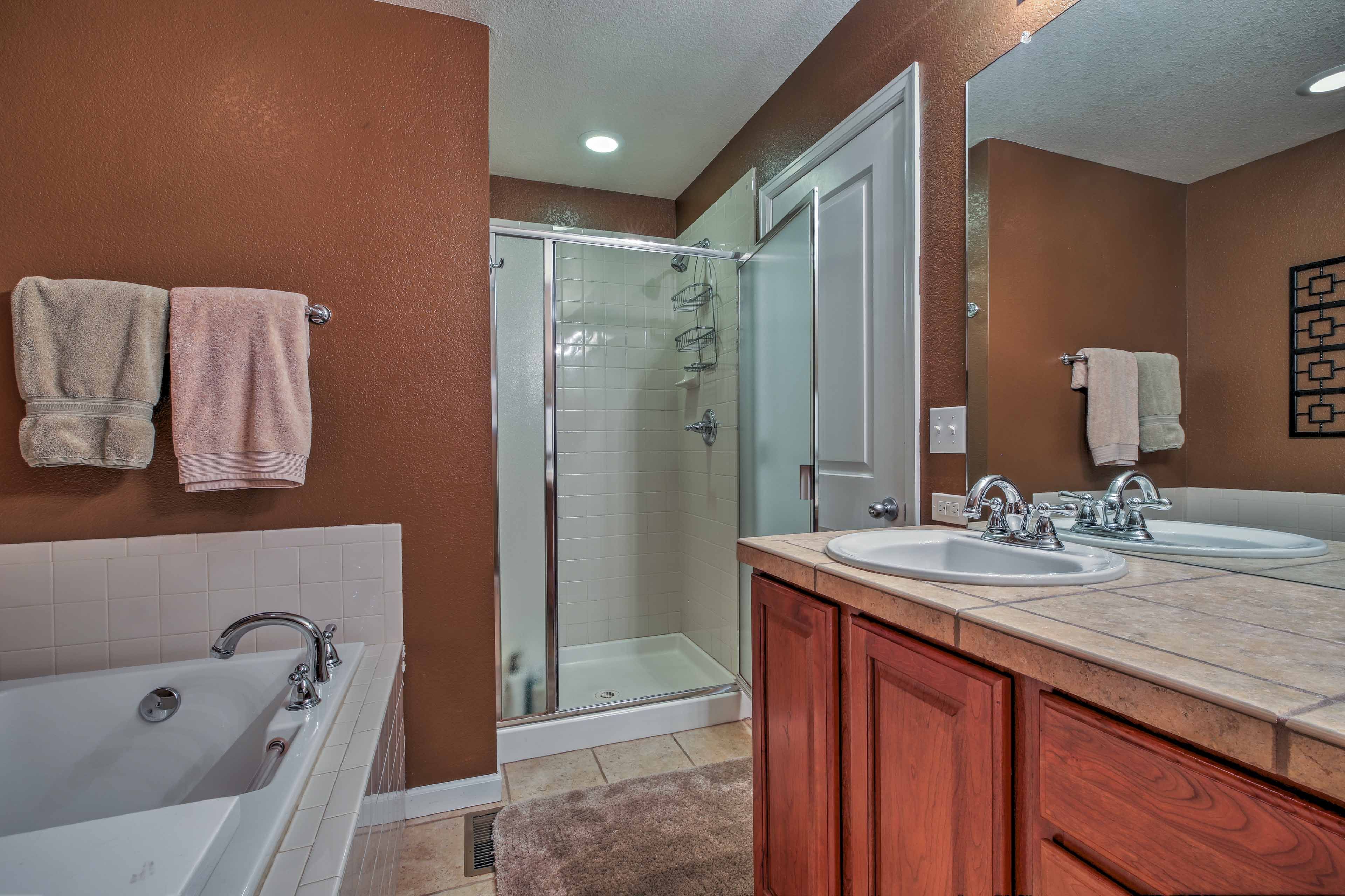 The en-suite is equipped with a tub and separate walk-in shower.
