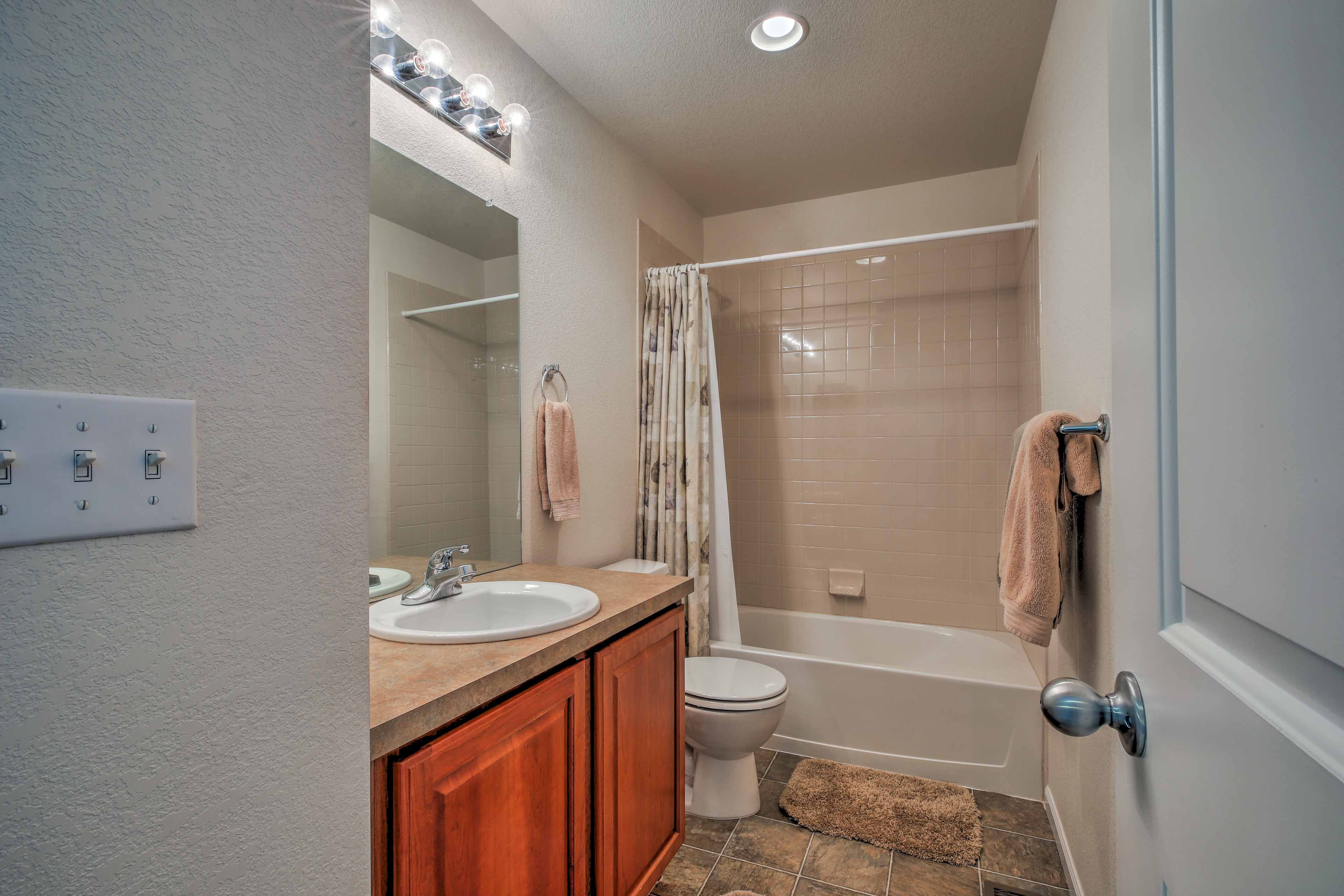 Wash up in the second bathroom, equipped with a shower/tub combo.