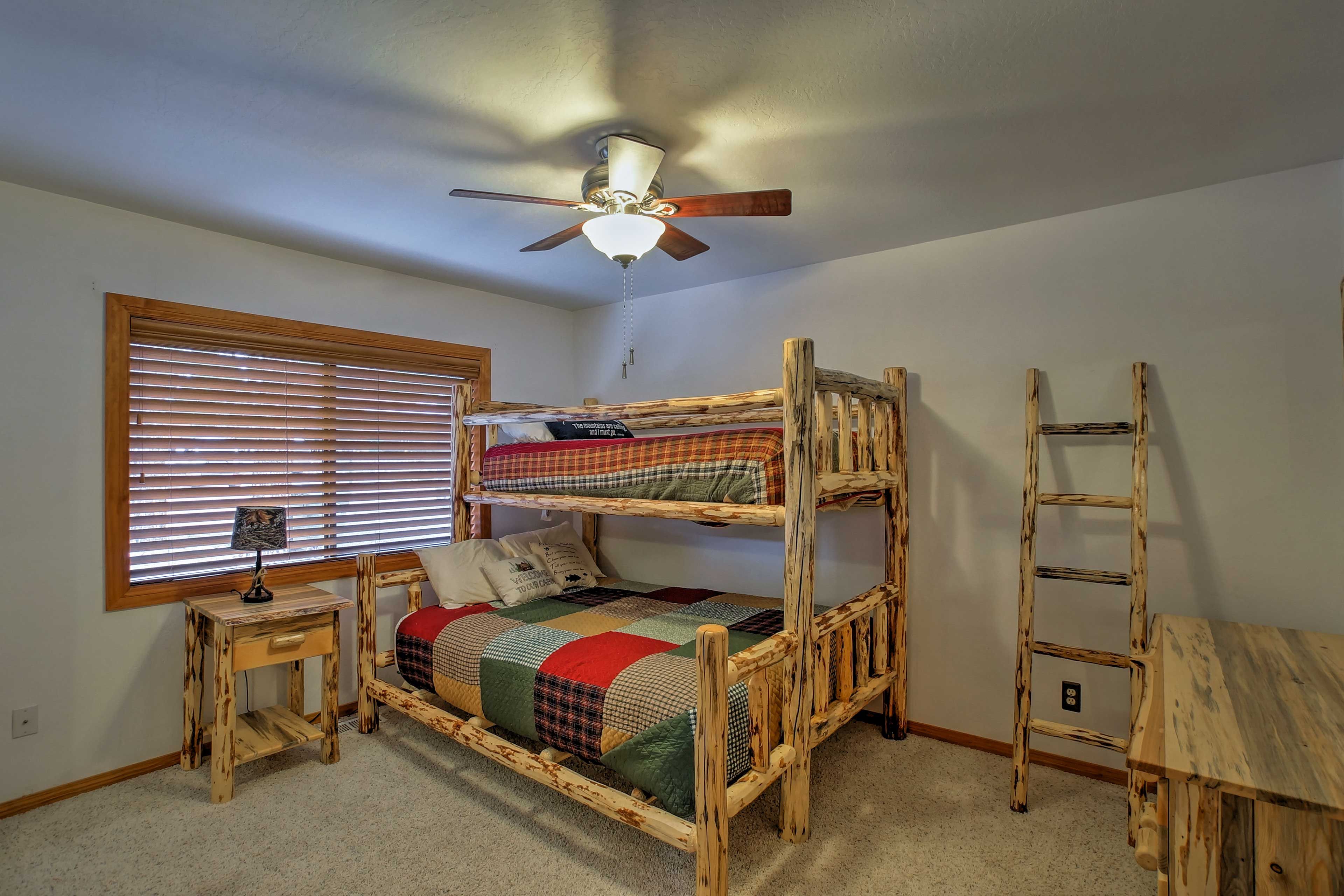 Find a twin XL/queen bunk bed in this second bedroom.