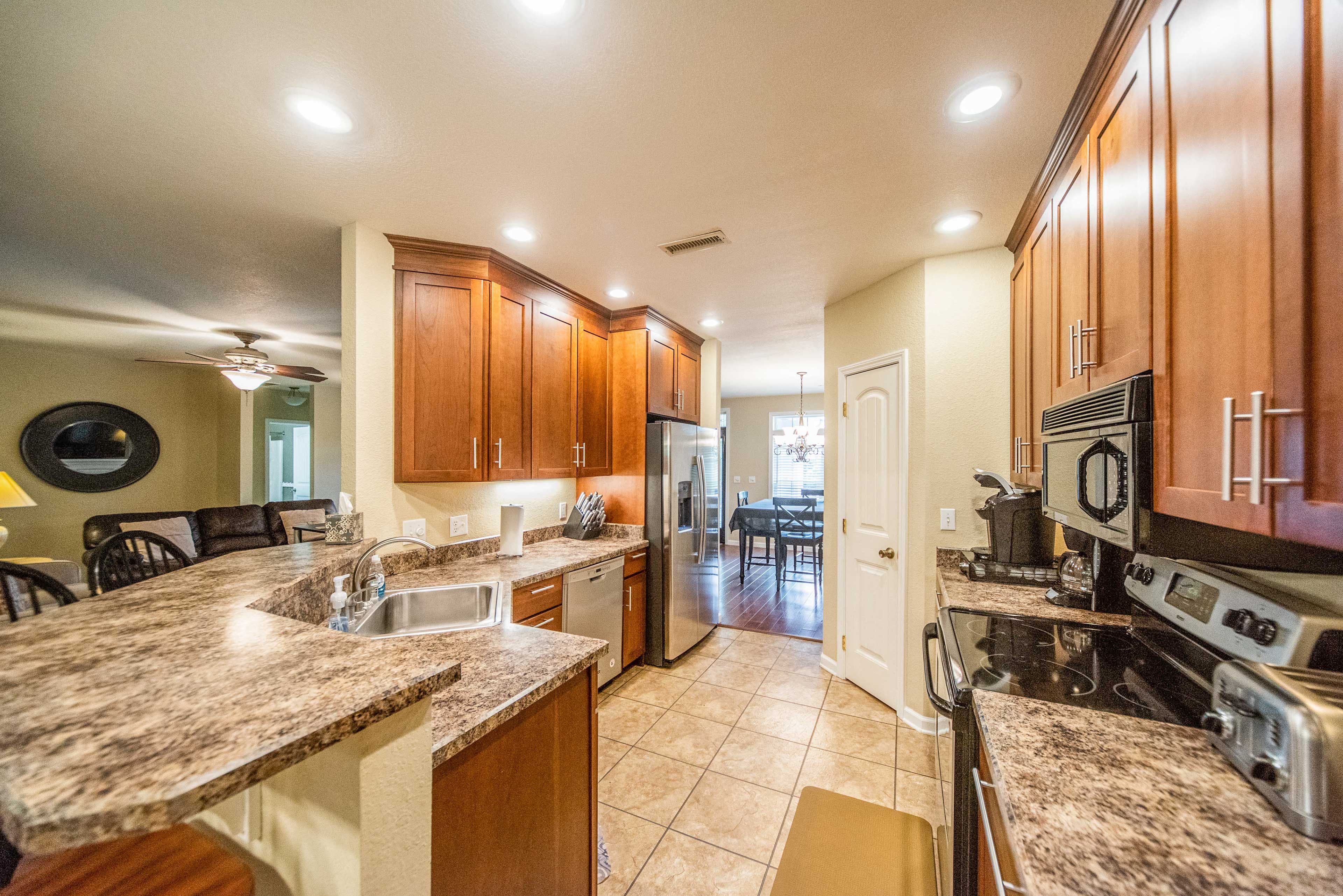 The kitchen hosts stainless steel appliances.