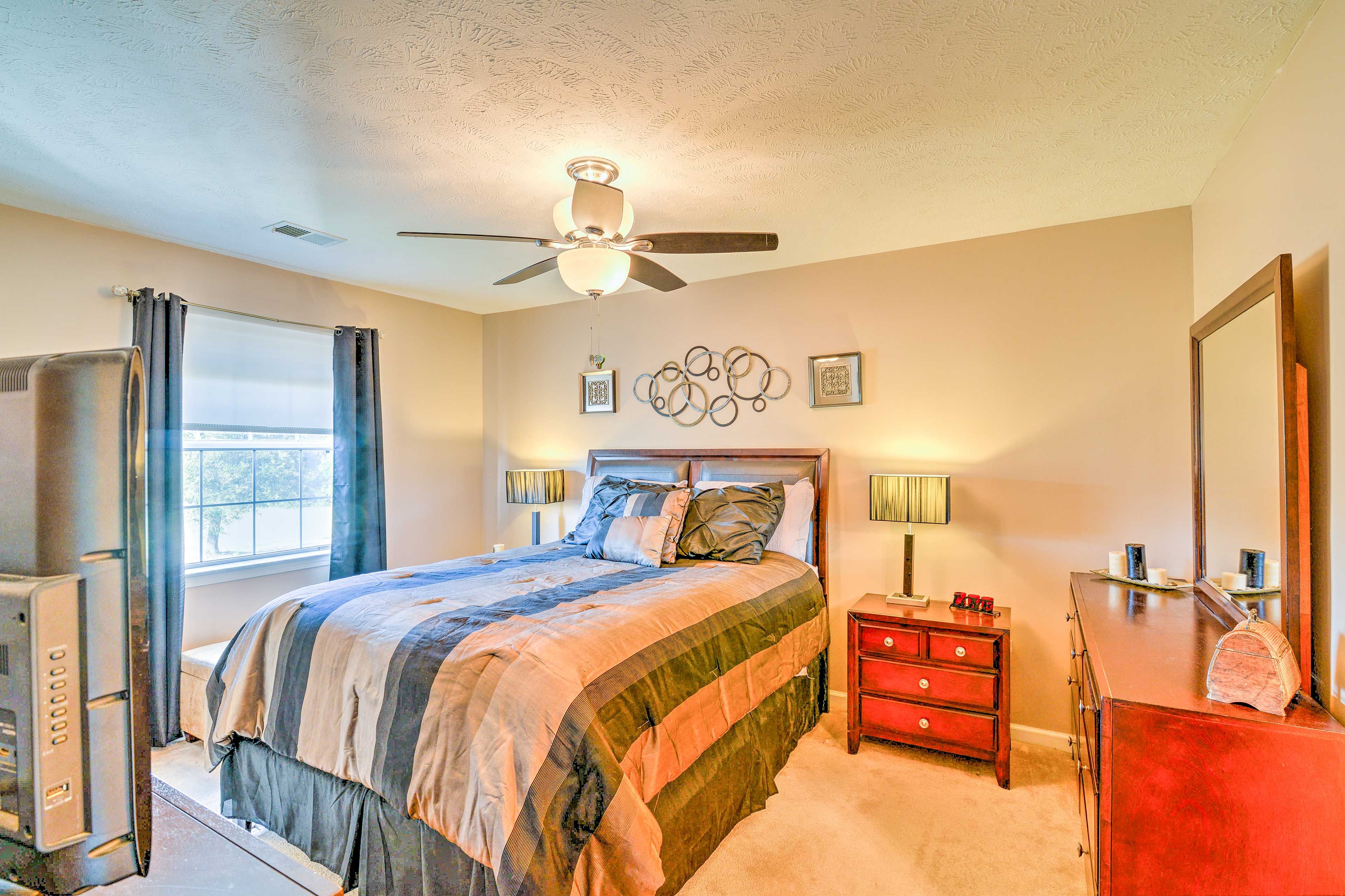 This bedroom offers a plush queen bed.
