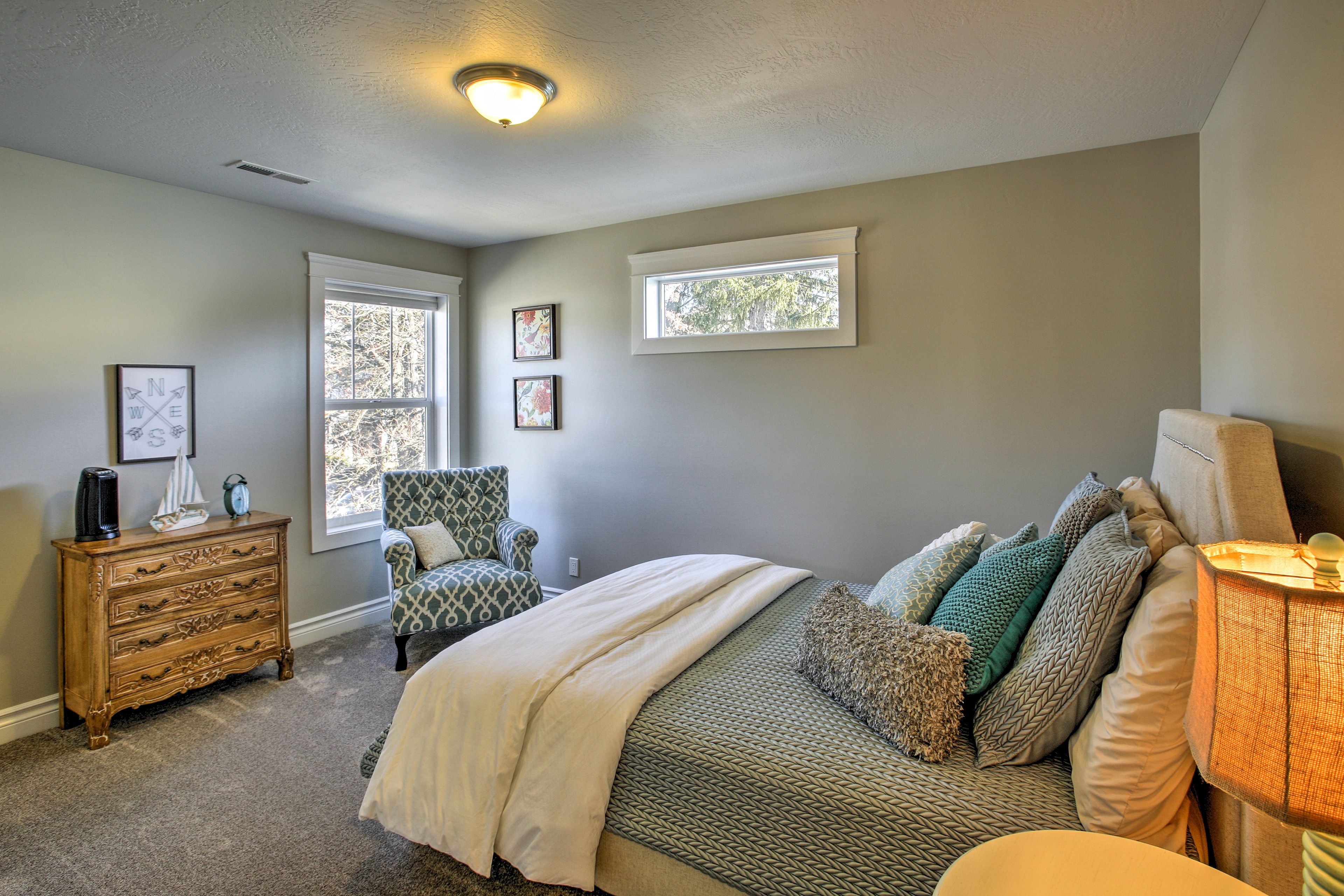 Rest easy with several throw pillows on this plush queen-sized bed.