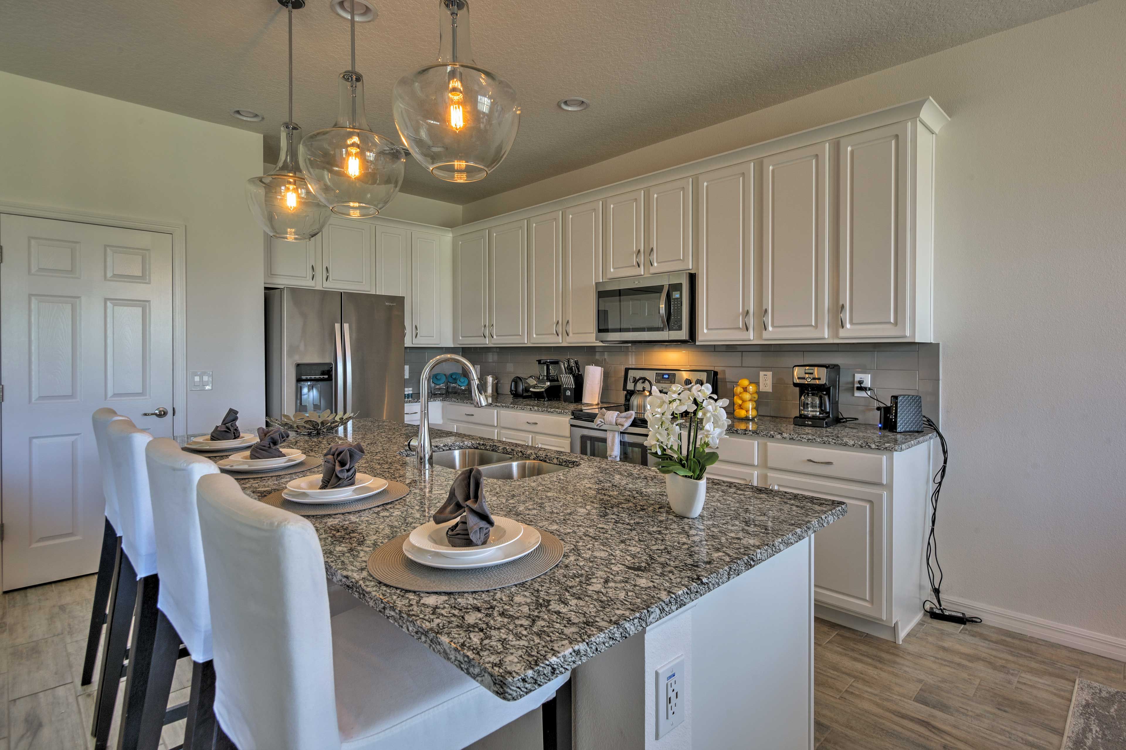 Pull up a chair at the breakfast bar to keep the chef company.