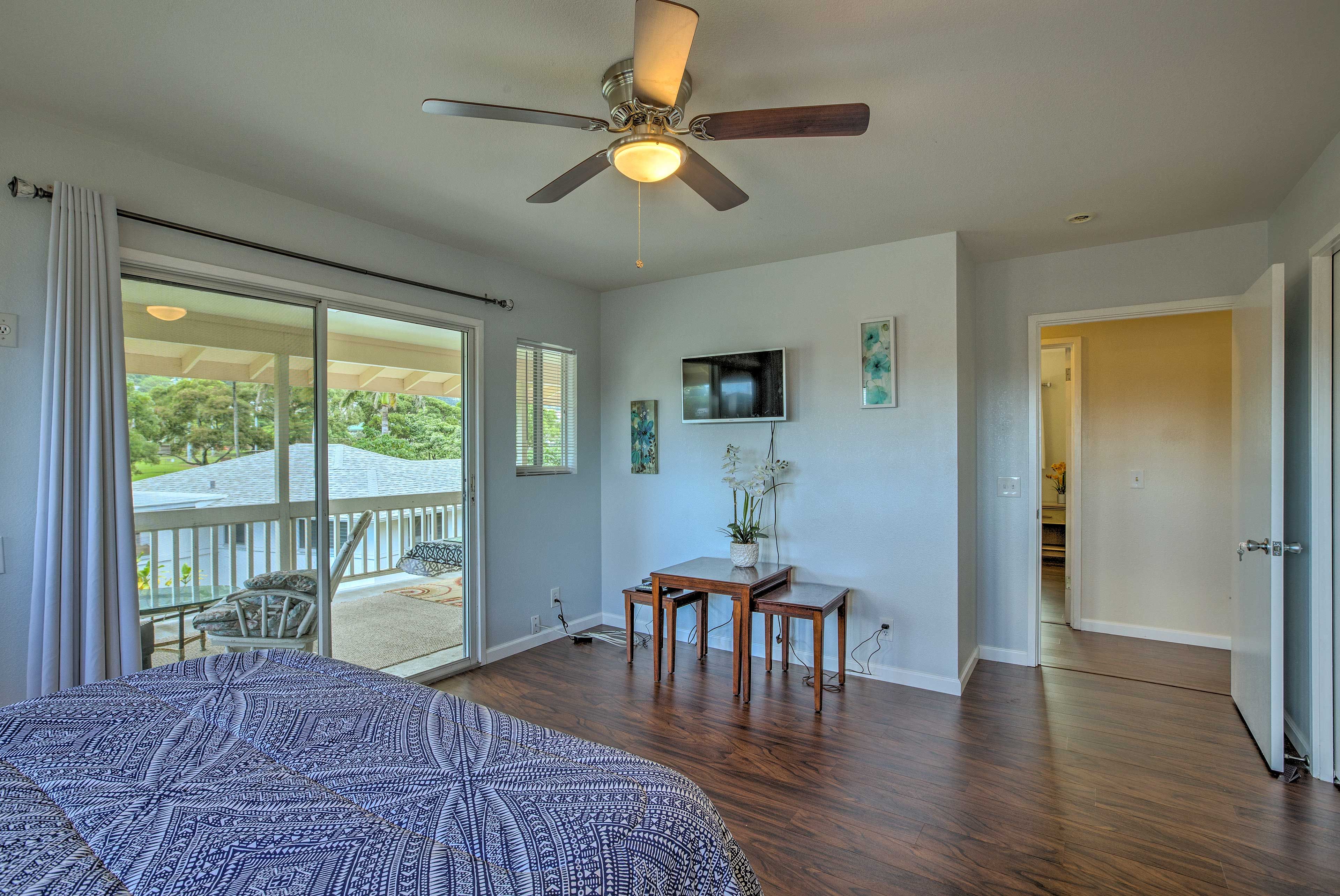 This bedroom offers a cable TV and access to the balcony.