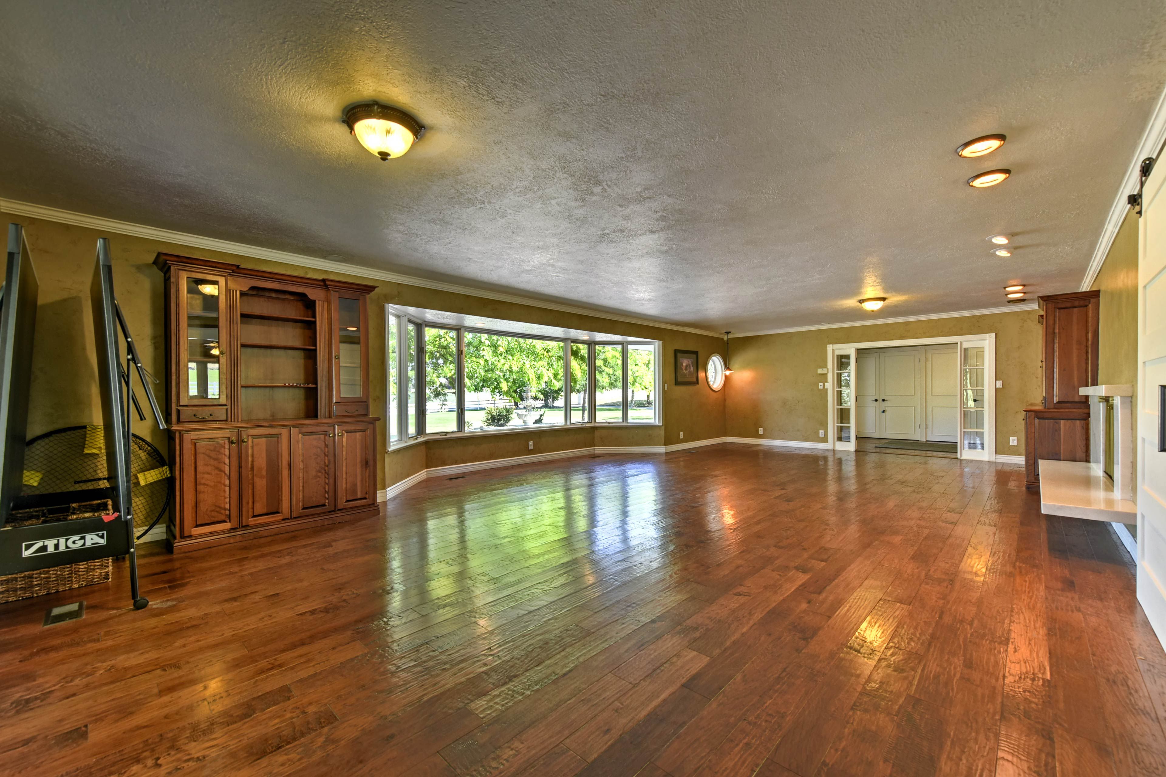 Hardwood floors line this spacious entertainment area.