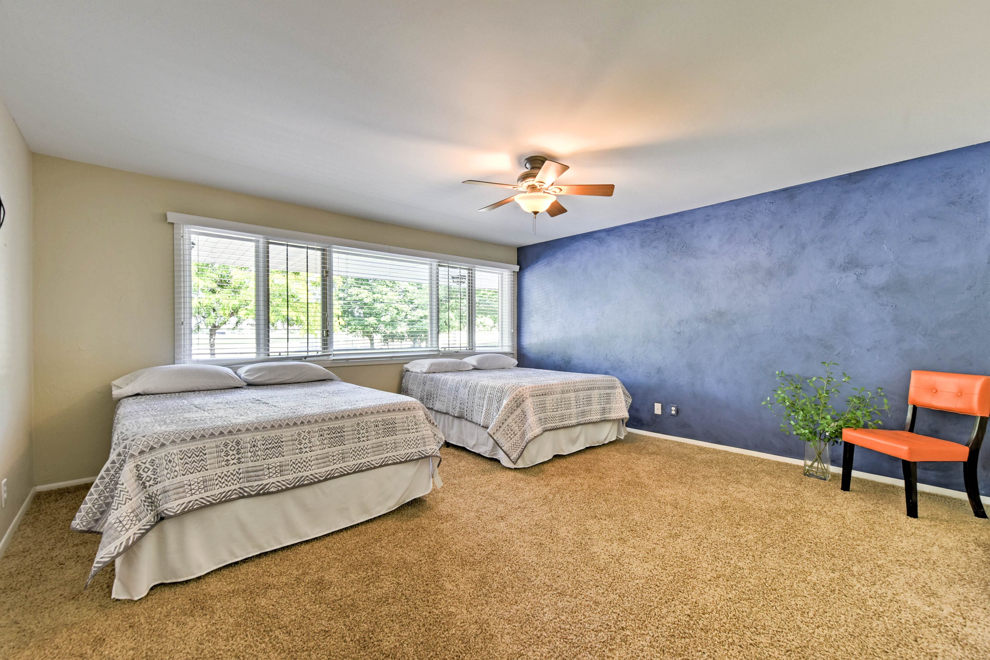 Blissful sleep awaits in the 2 queen beds outfitting this bedroom.