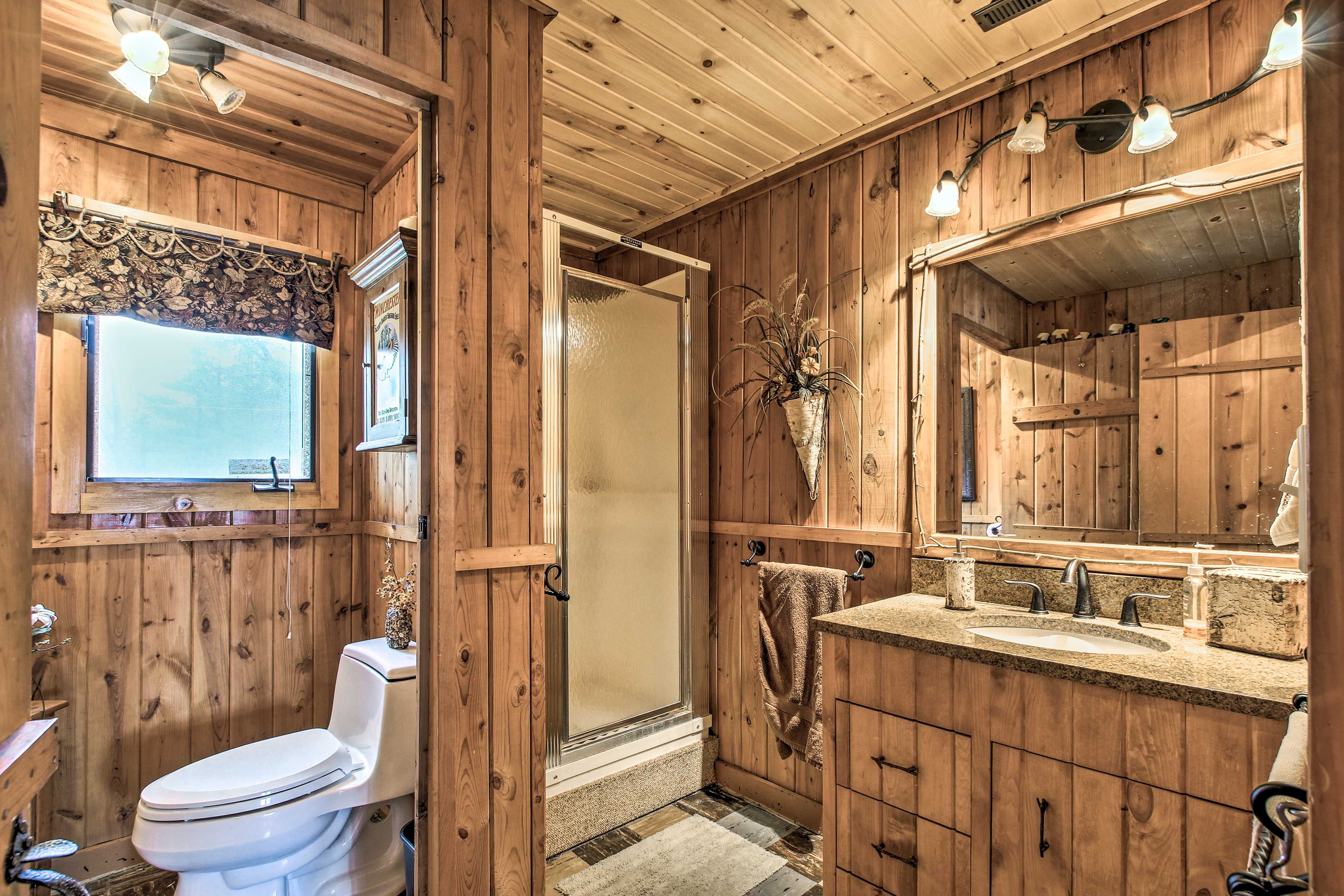 Freshen up for your day in front of this granite vanity.