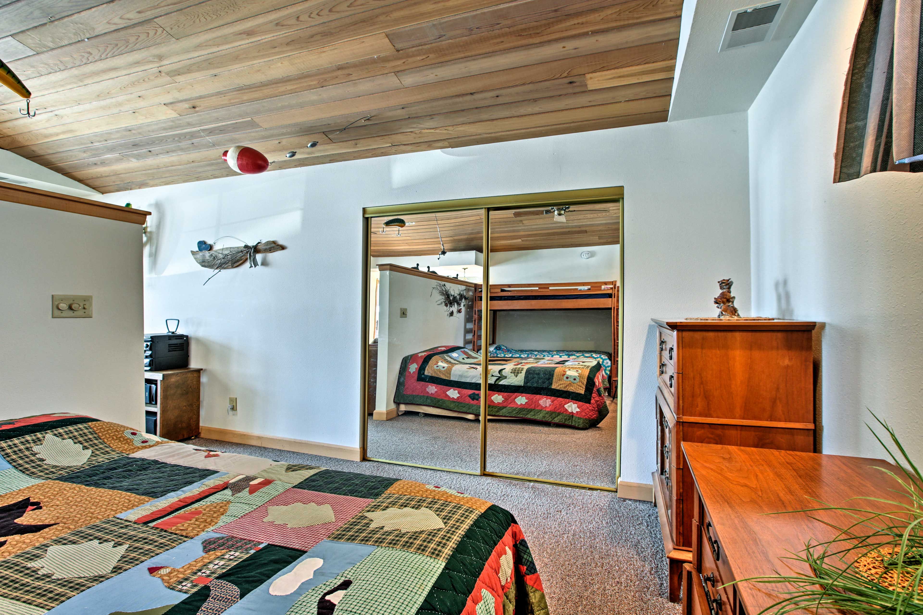 The bedroom has a queen bed and a twin bunk bed.
