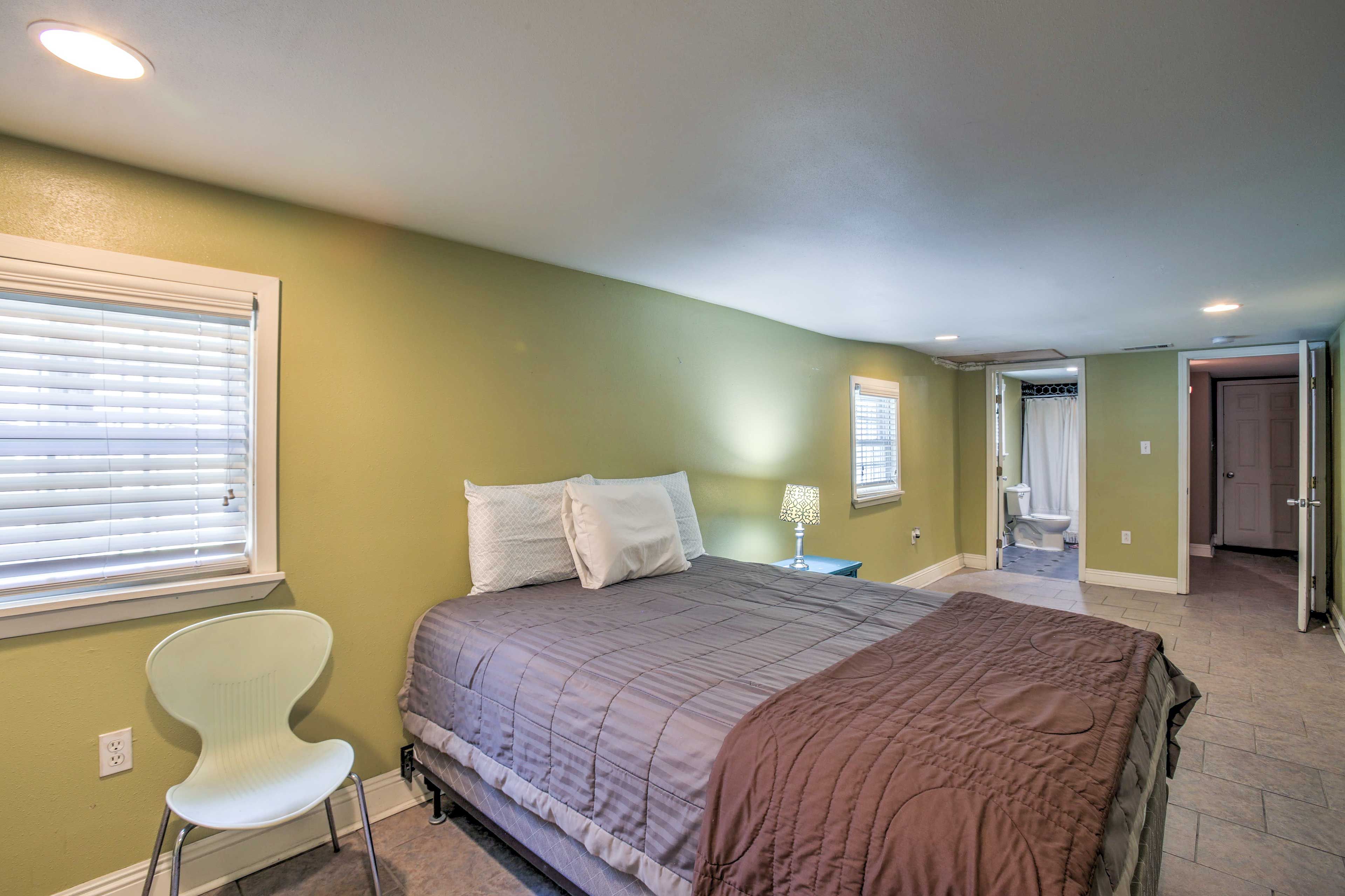 Downstairs, the bedroom suite has a queen bed and an en-suite bathroom.