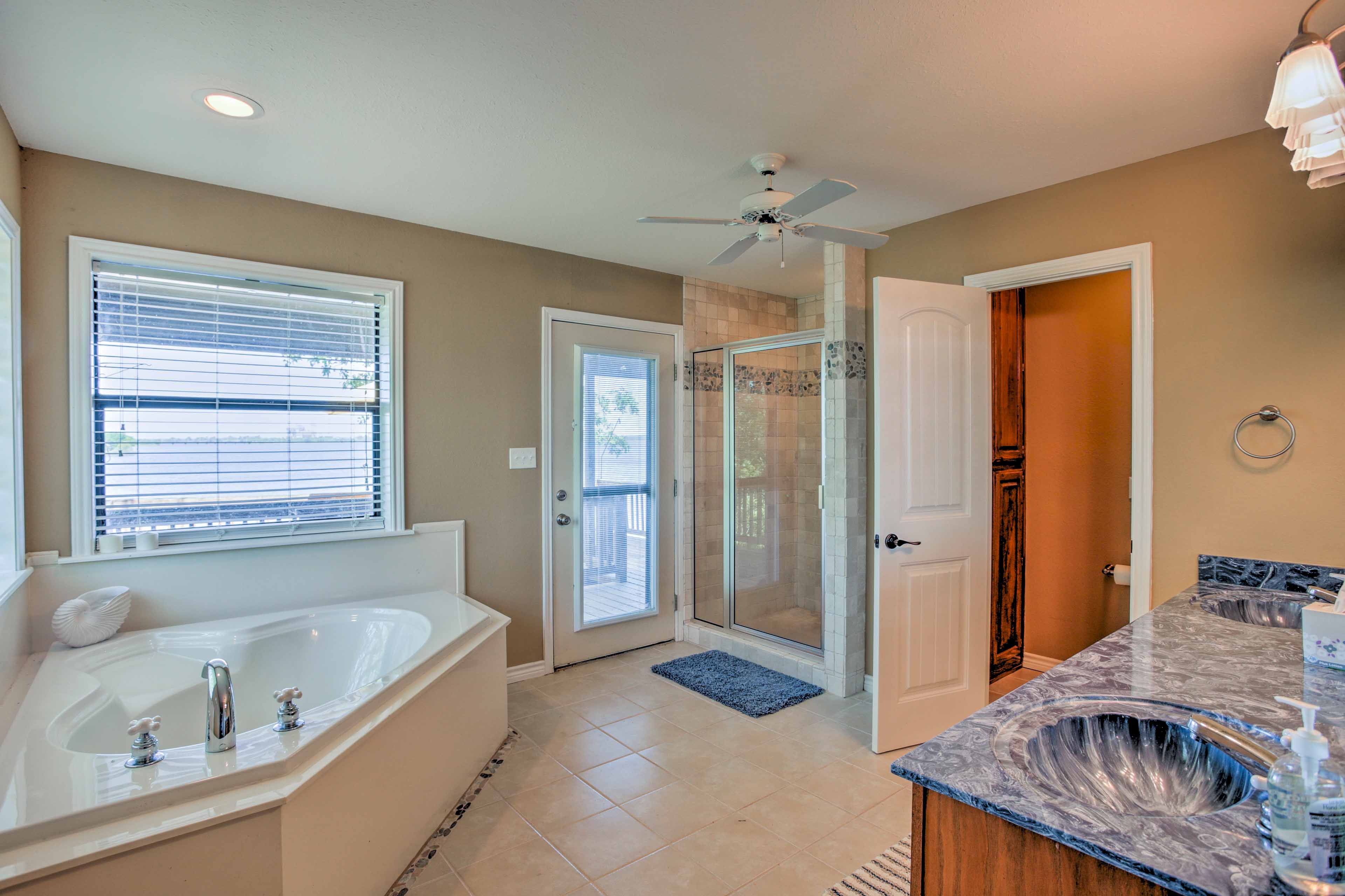 The en-suite bathroom features a walk-in shower and separate tub.