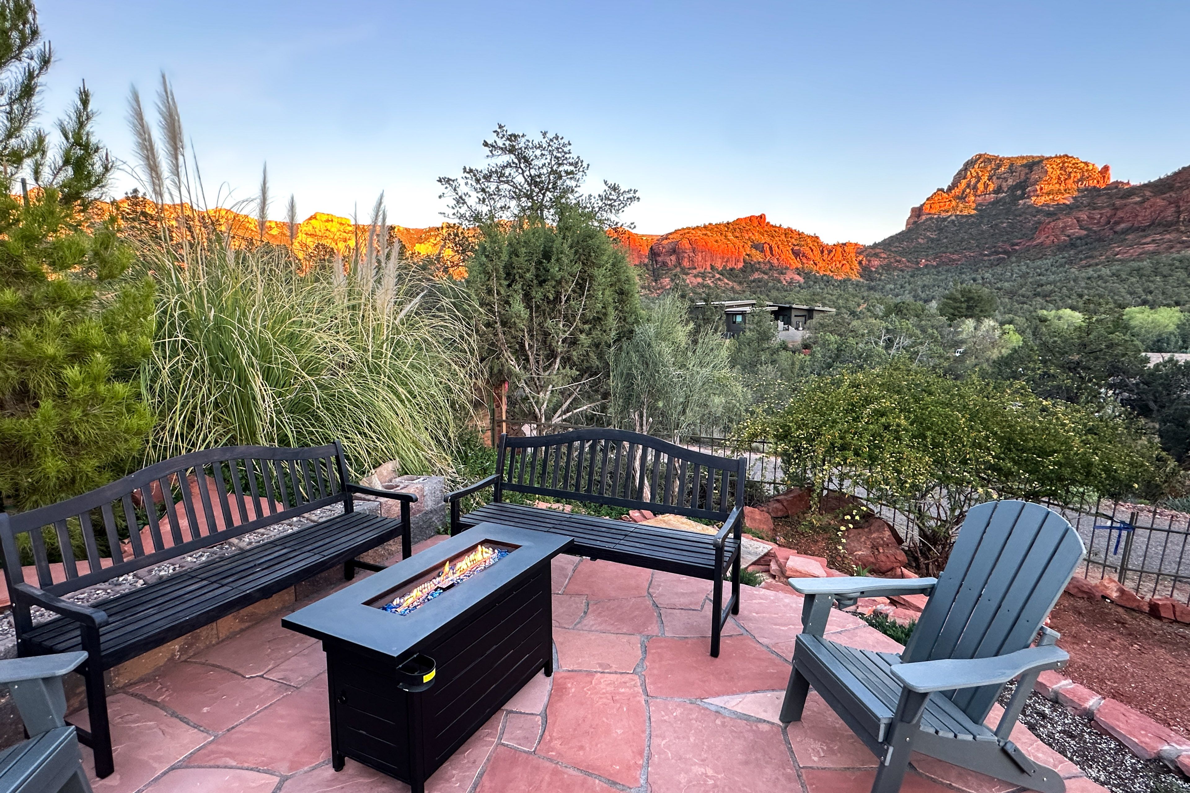 Gas fire pit w/ blue glass stones at golden hour, canyon turns orange behind you