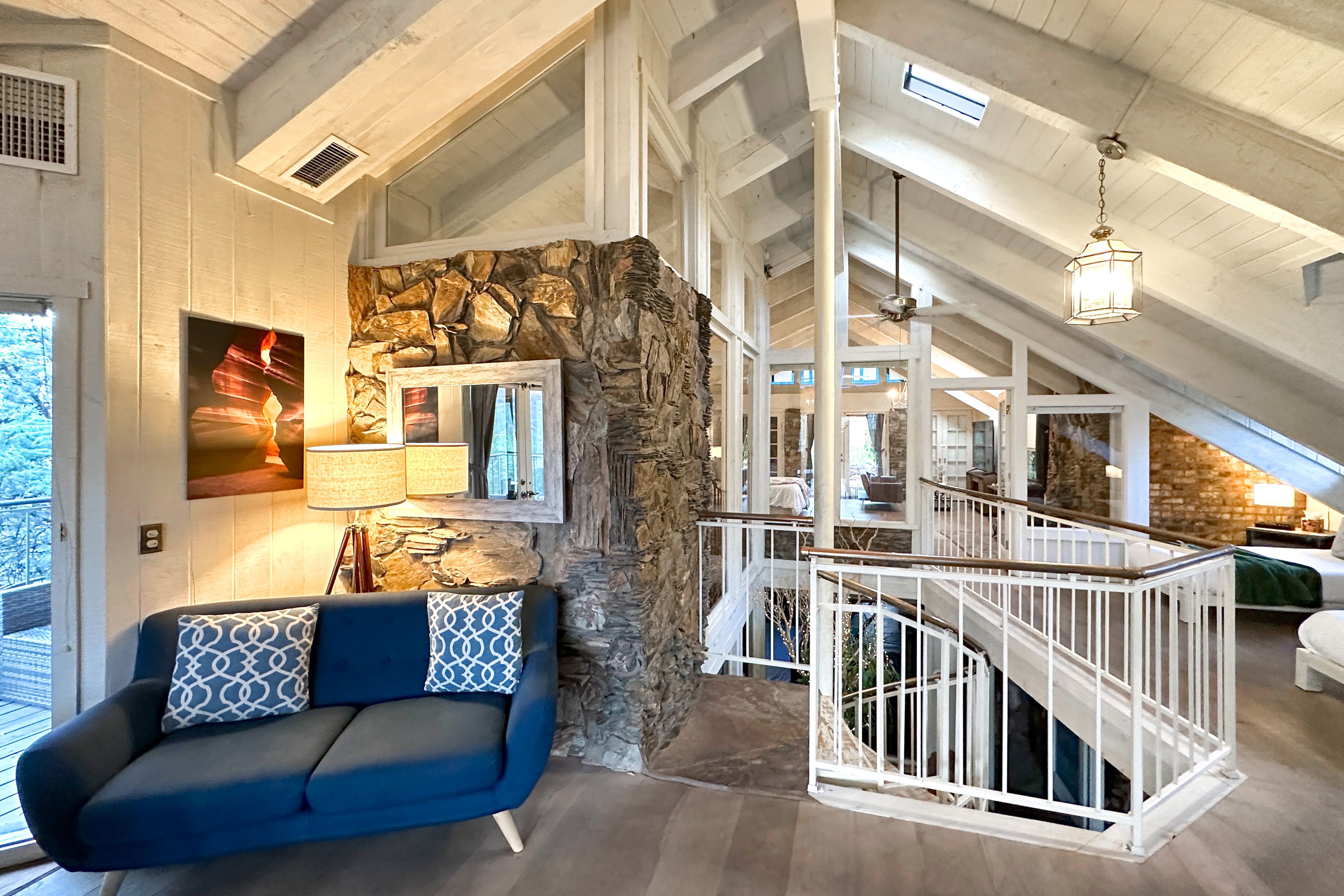 Upper landing and spiral staircase, 3 levels connected by stone and light