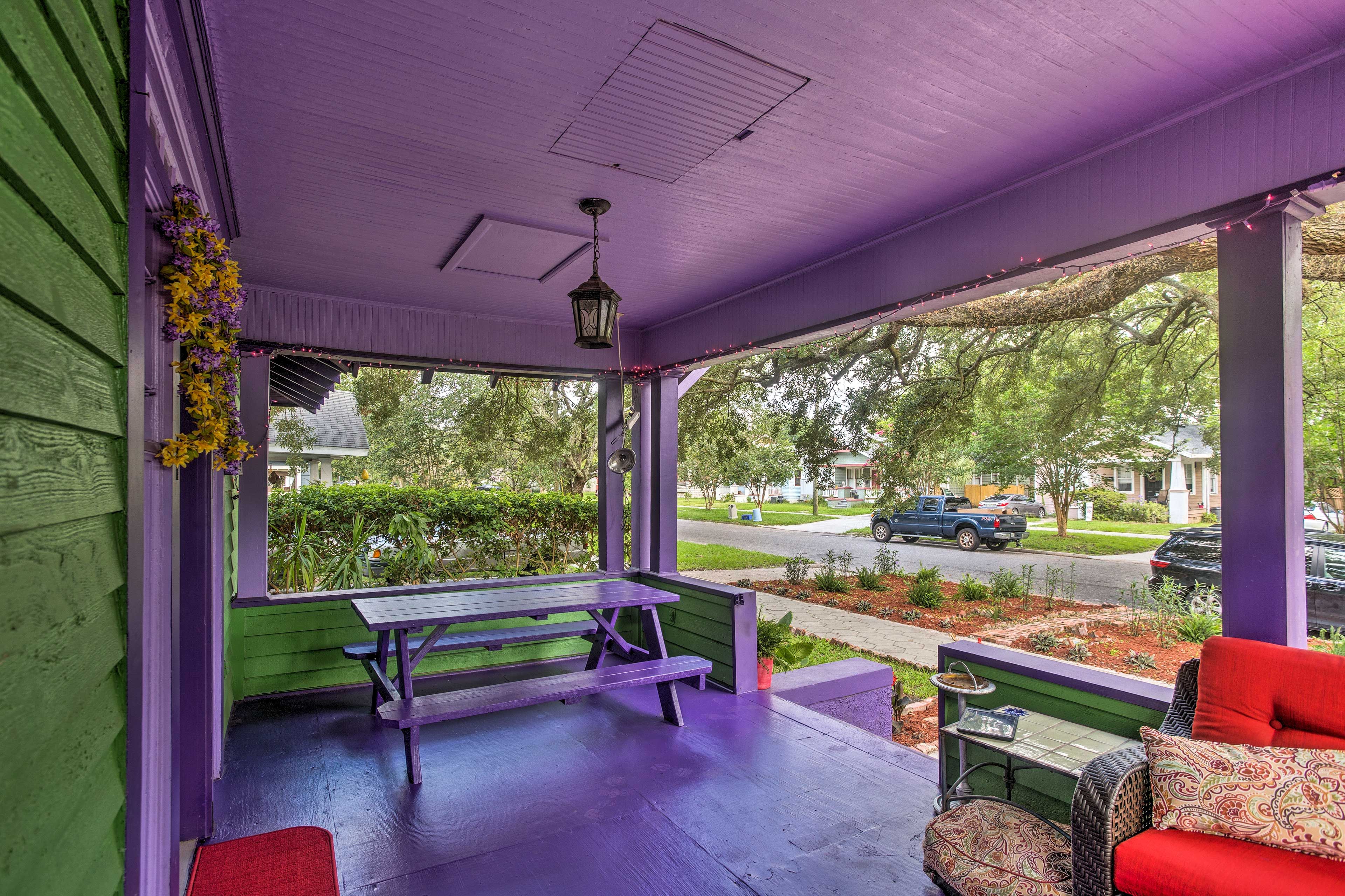This eclectic hideaway includes a front porch and backyard!