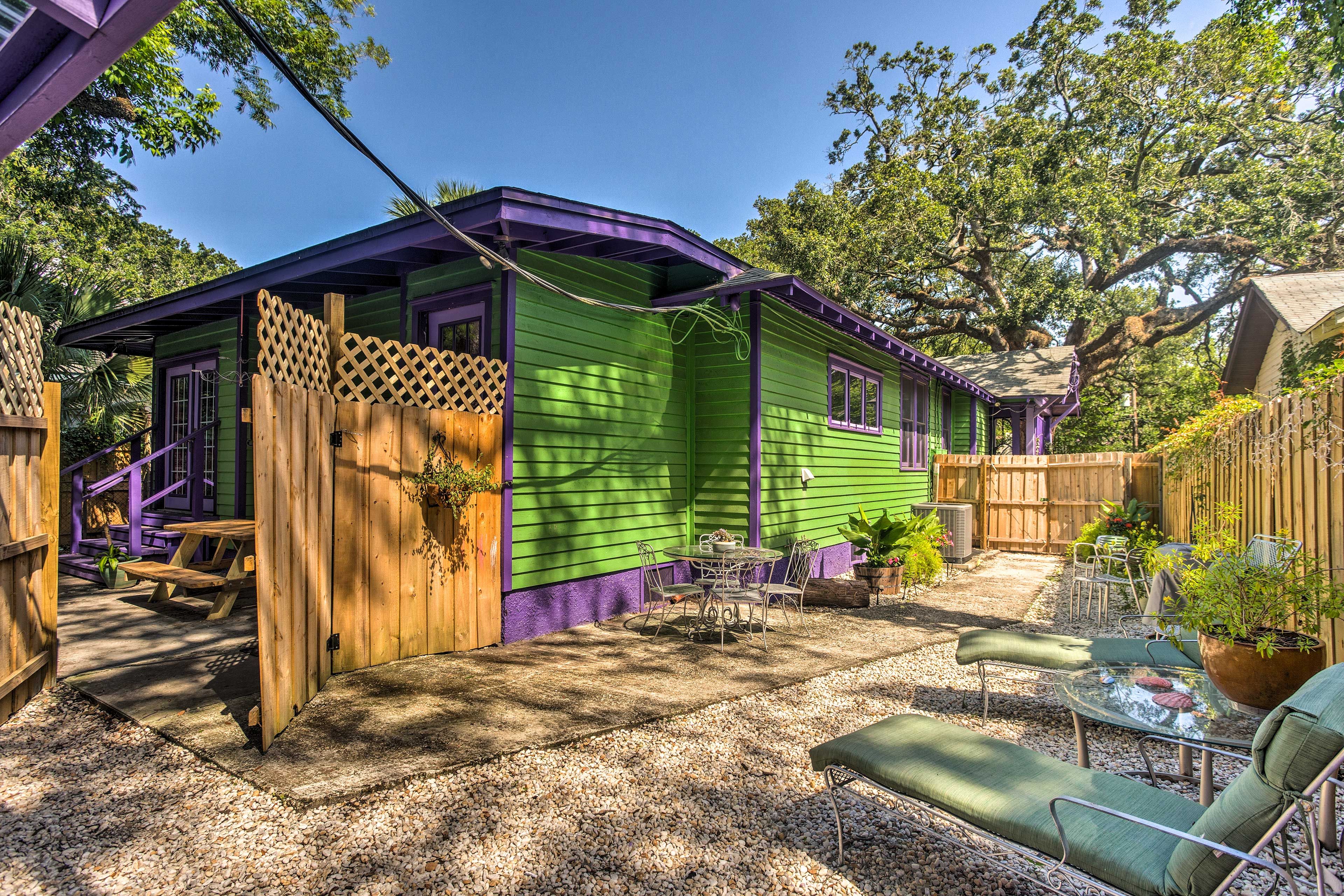 The backyard also has patio furniture and lounge chairs.