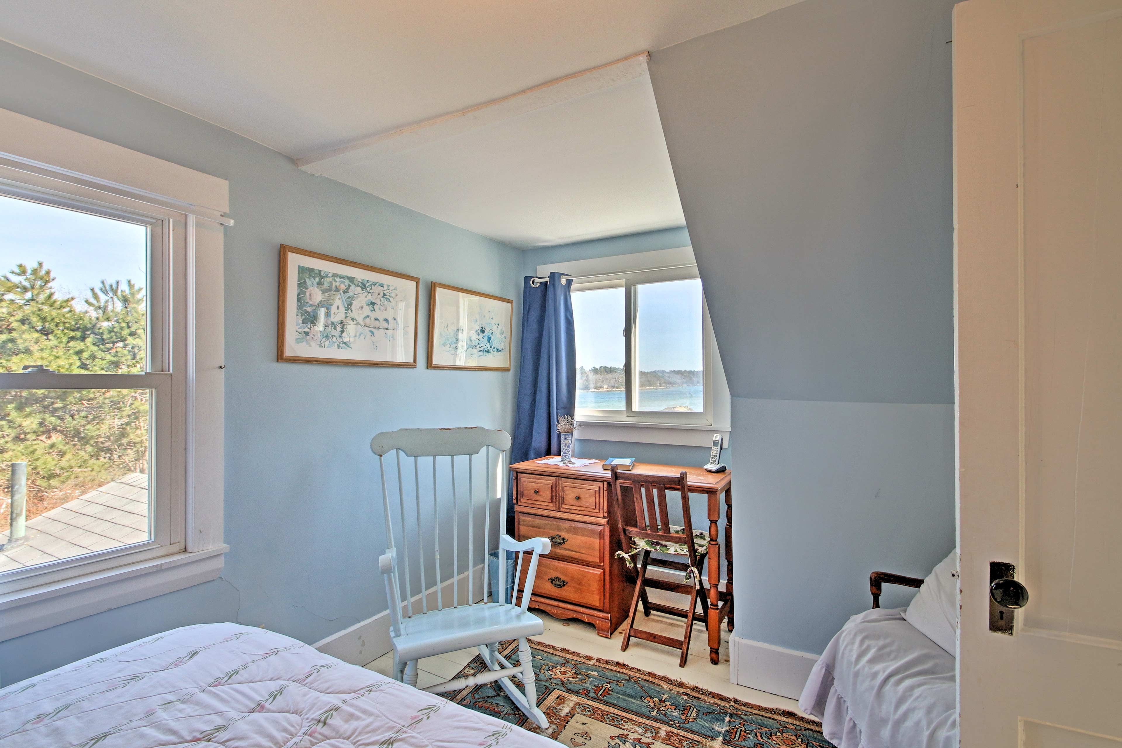 Have a seat at the desk to read a book while glancing out at the water.