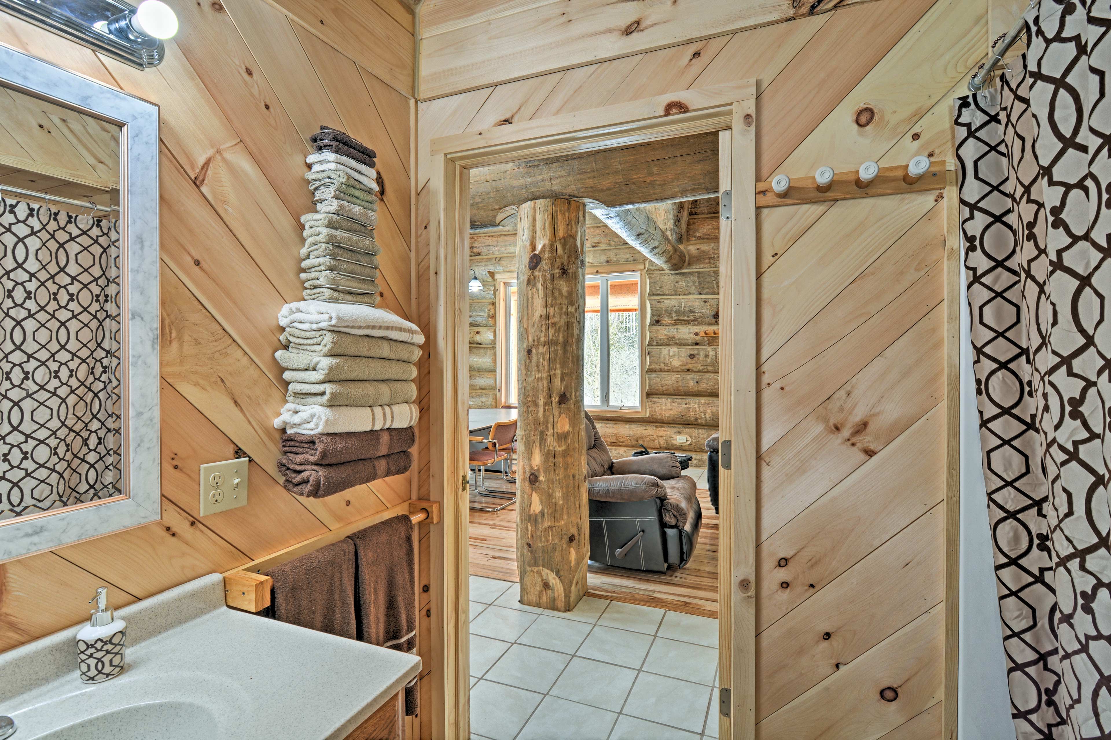 The bathroom is stocked with plenty of towels.