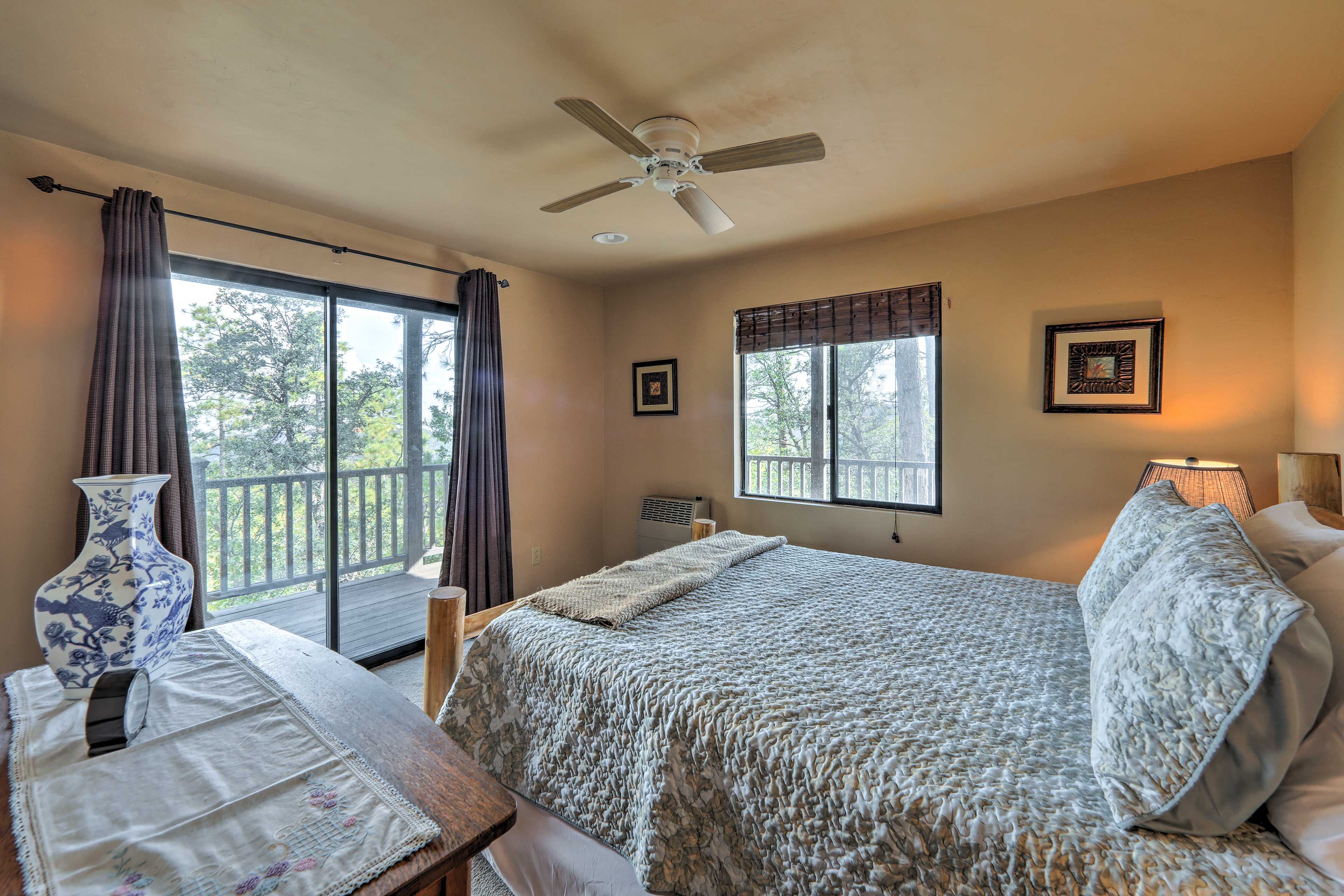 The sliding glass door reveals views of the towering pines.