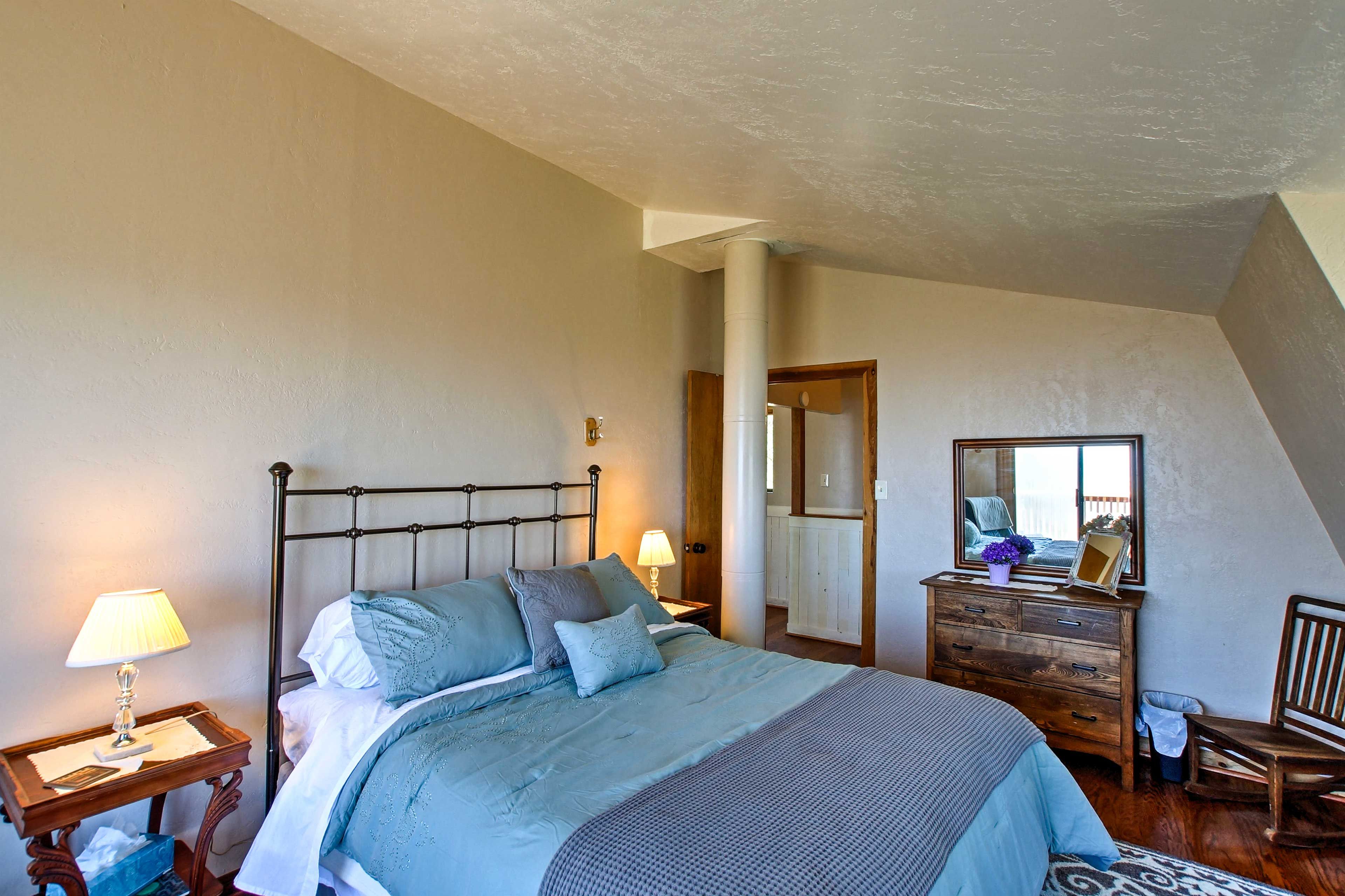 Climb under the covers of this comfy queen bed.