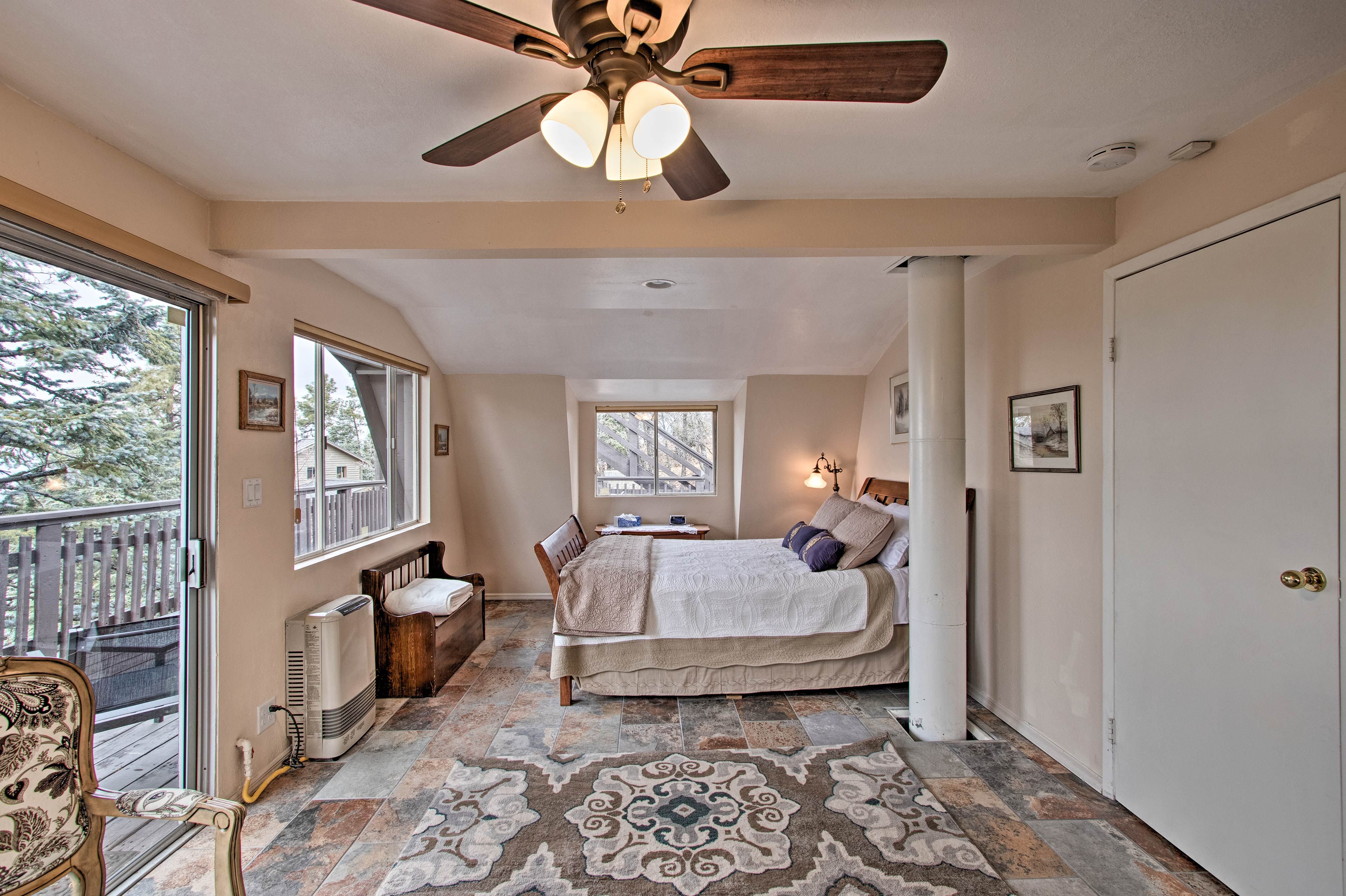 The primary bedroom offers a queen bed and private deck access.
