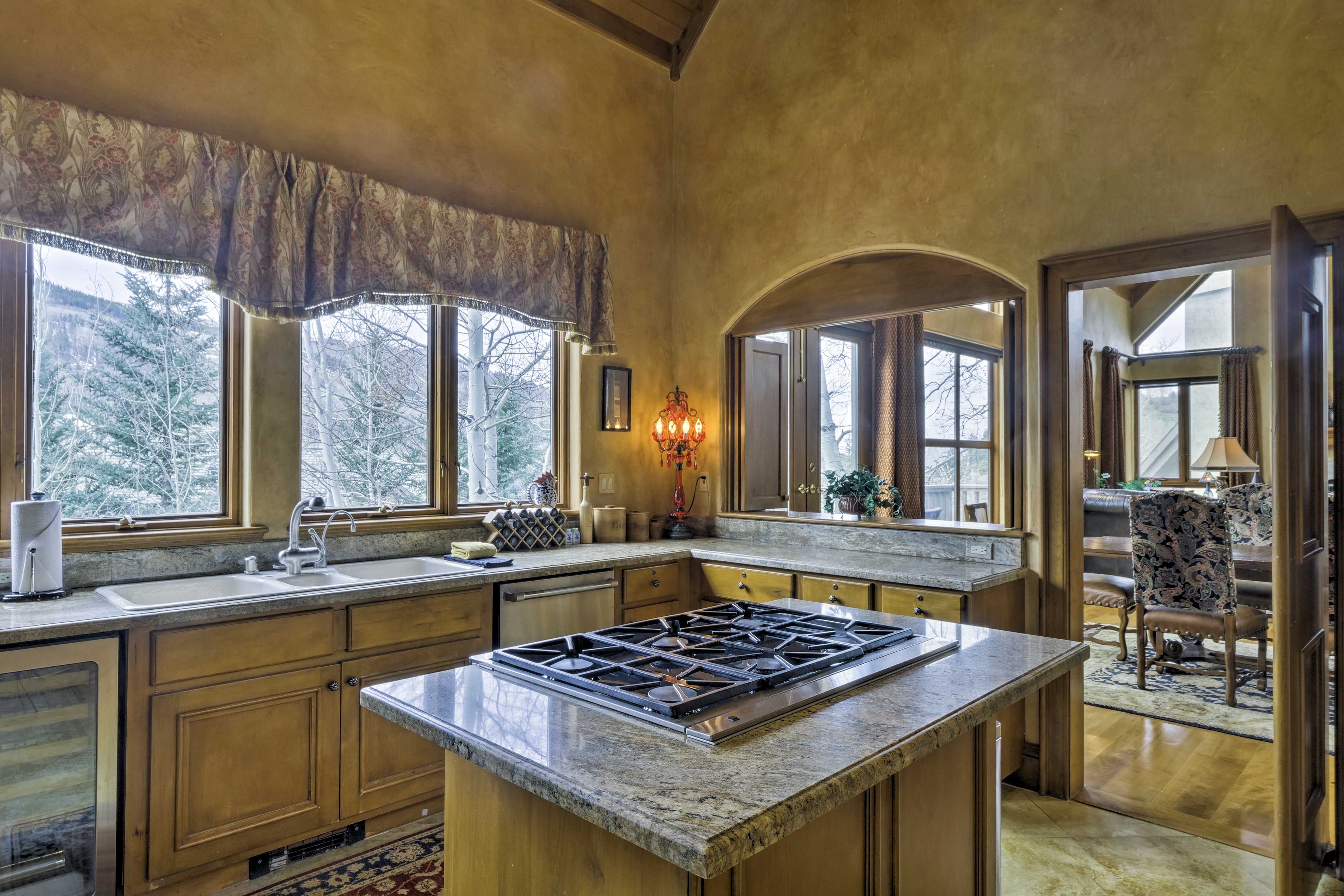 The fully equipped kitchen has granite counters and stainless steel appliances.