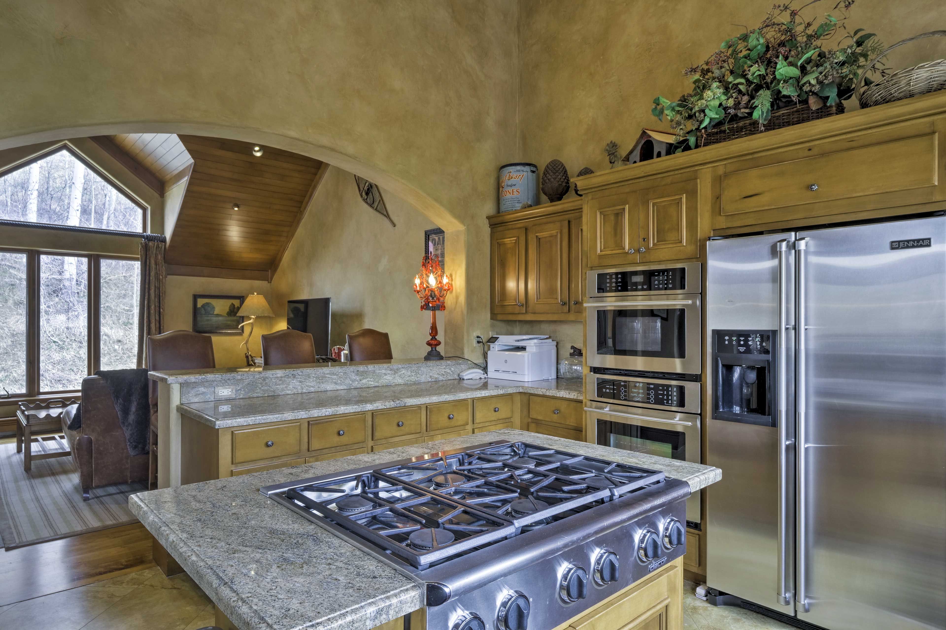 The kitchen also features 6 stove top burners and a wine cooler.