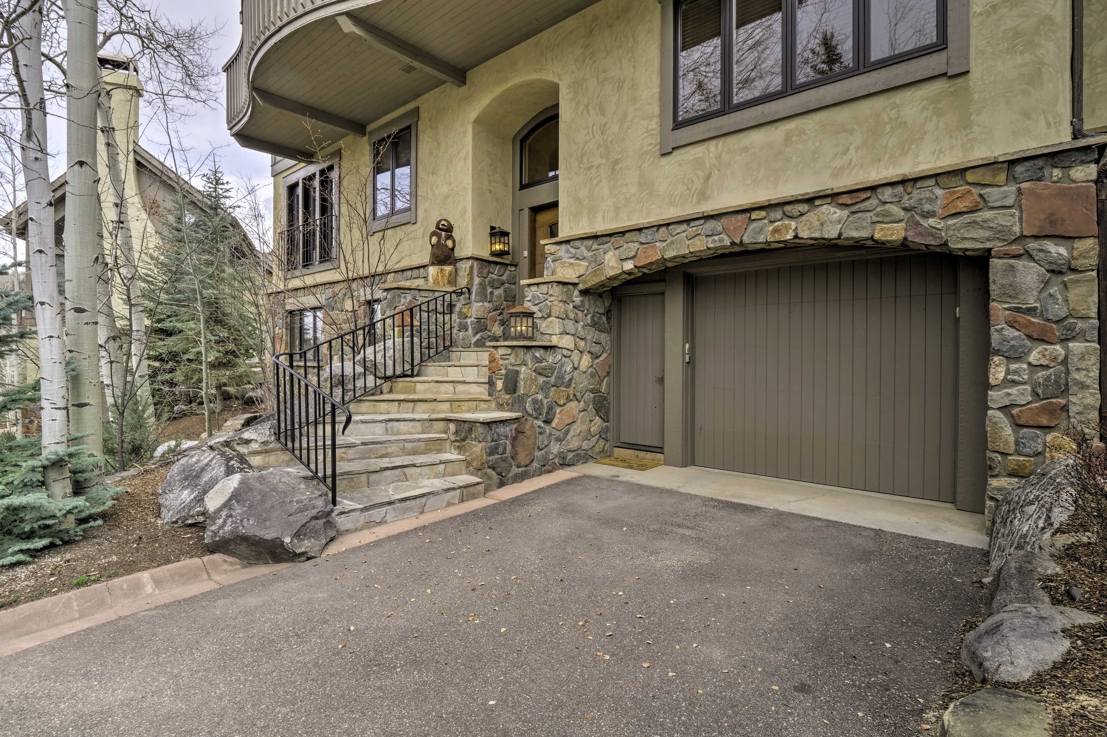 Two vehicles can be parked in the driveway.