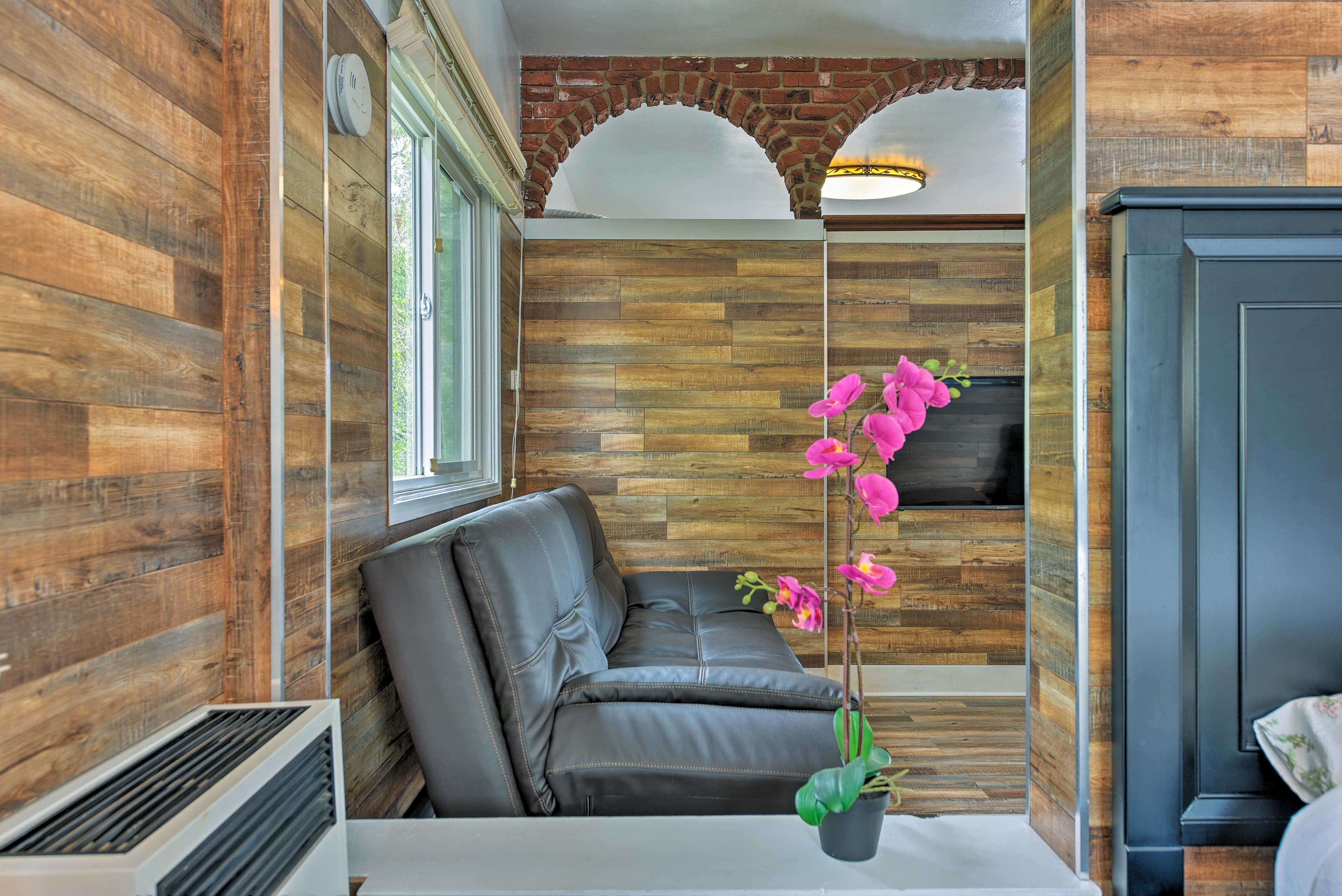 A pass through window connects the bedroom to the living area.