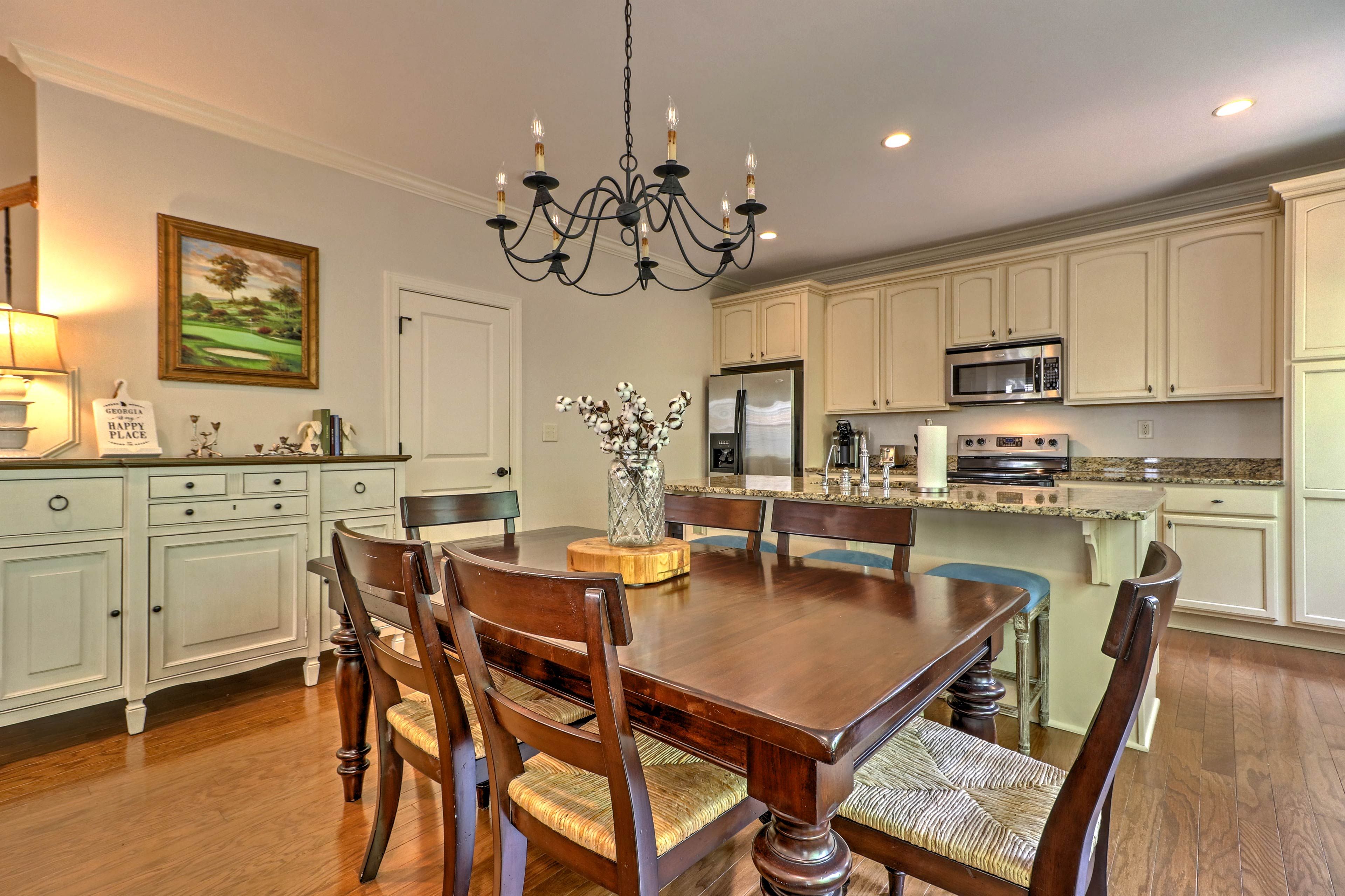 There are 6 seats at the wood dining table along with bar stool seating.