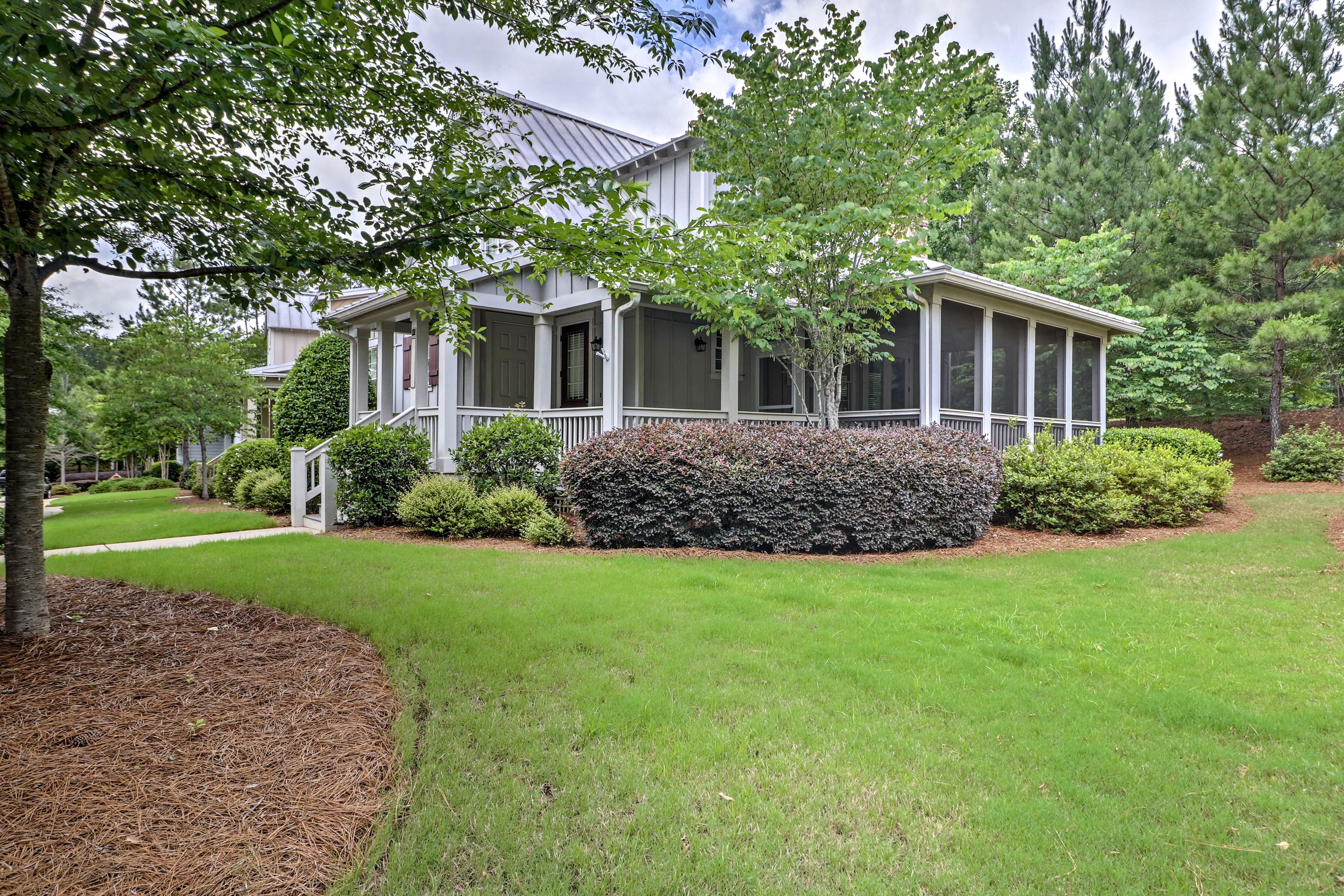 Enjoy views of the lush yard as you lounge on the porch.