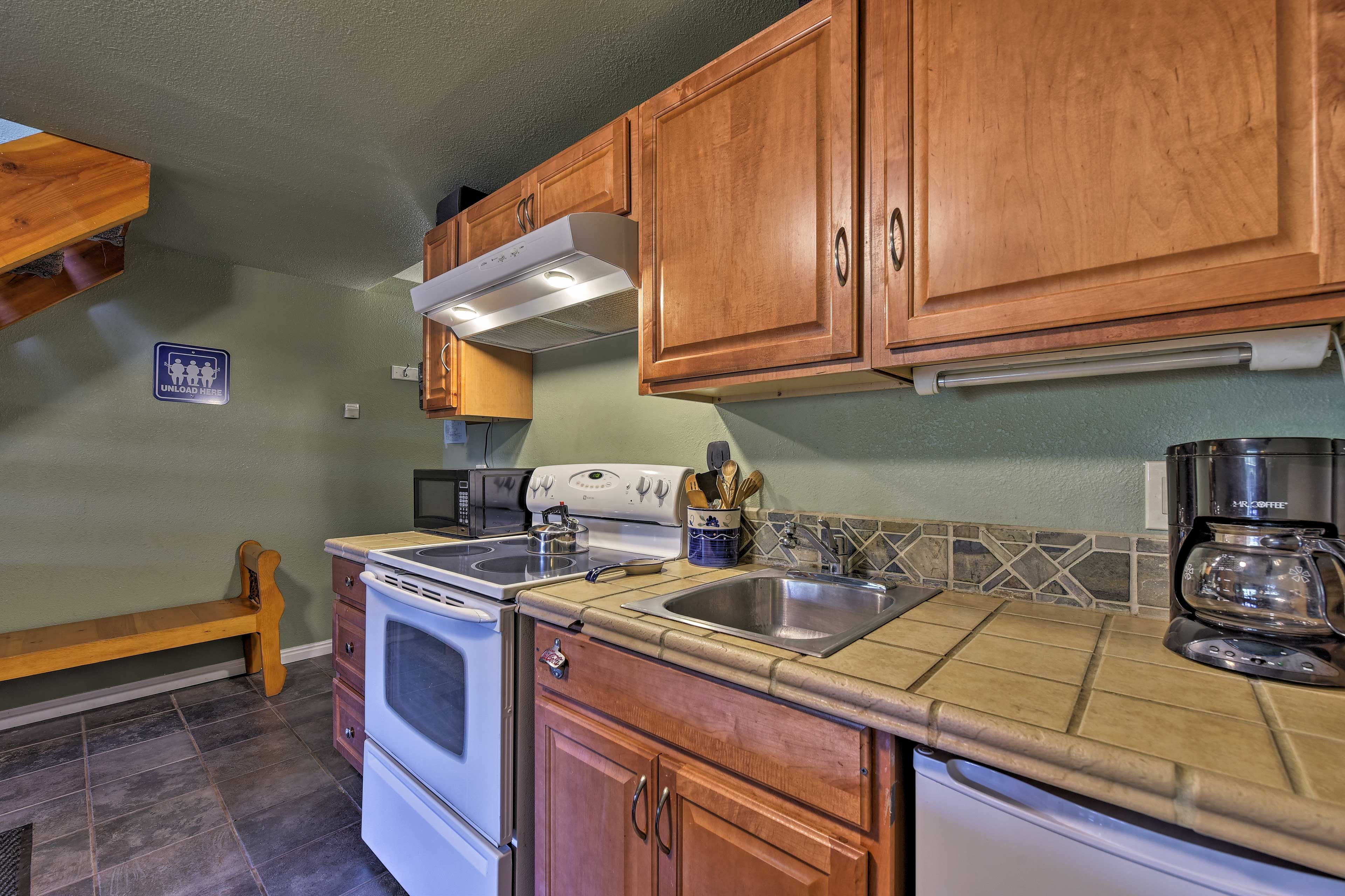 The kitchenette offers a mini fridge, microwave, stove top and oven.