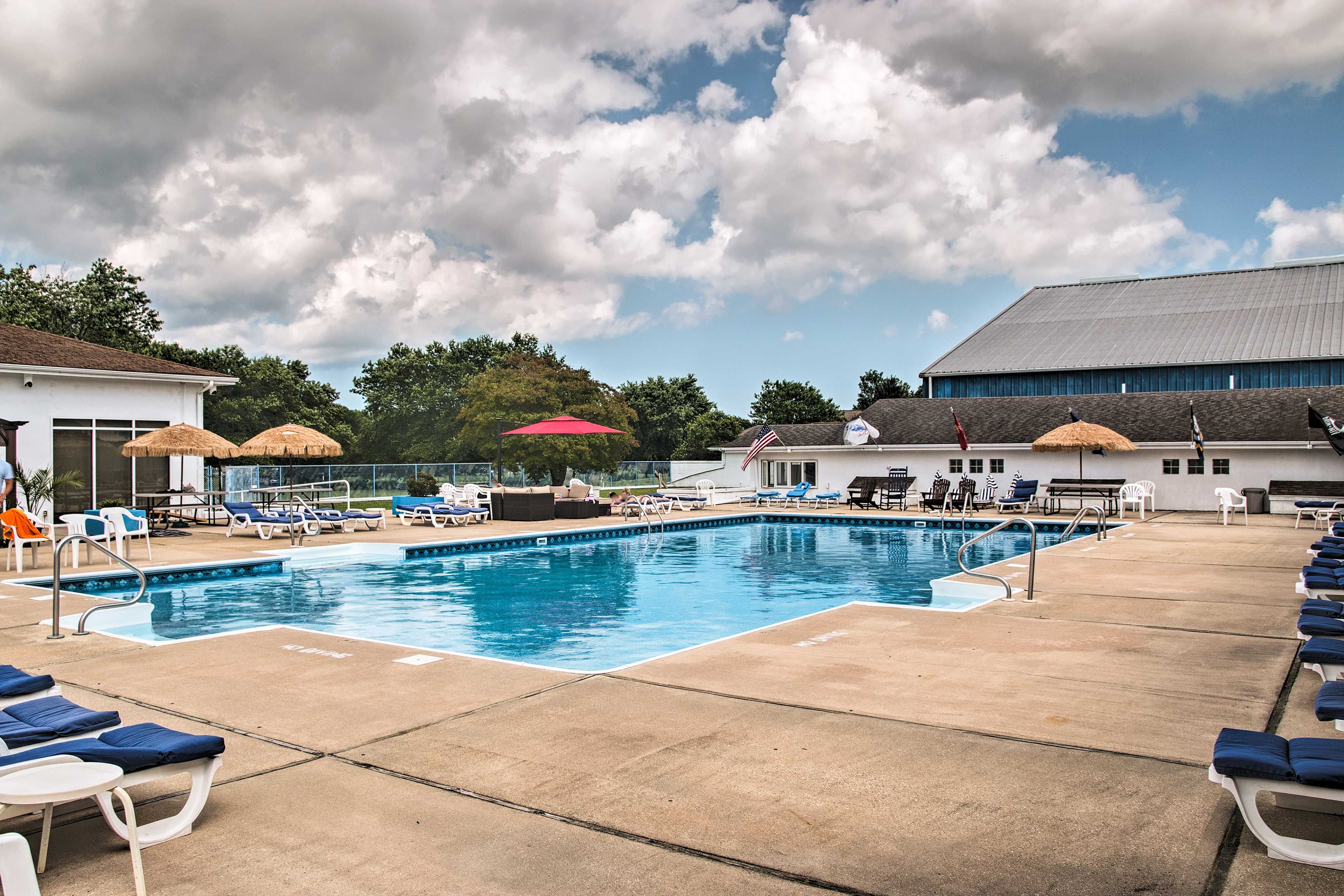 Recline on a chaise lounge chair beside the spacious community pool.